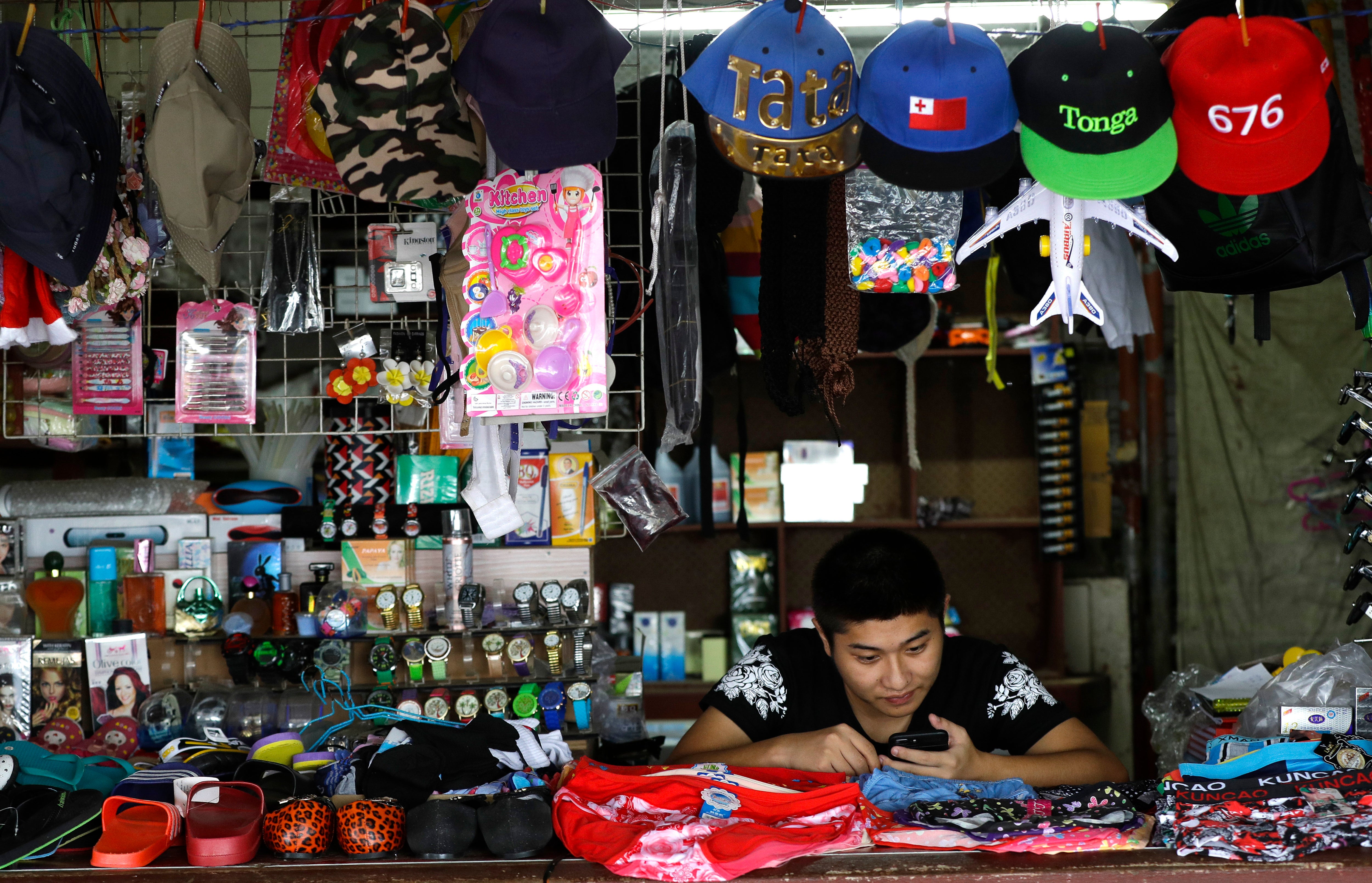 File: A shopkeeper waits for business in Nuku'alofa, Tonga in April 2019. The island nation of Tonga has reported its first-ever case of Covid-19, Friday 29 Oct 2021 after a traveler from New Zealand tested positive