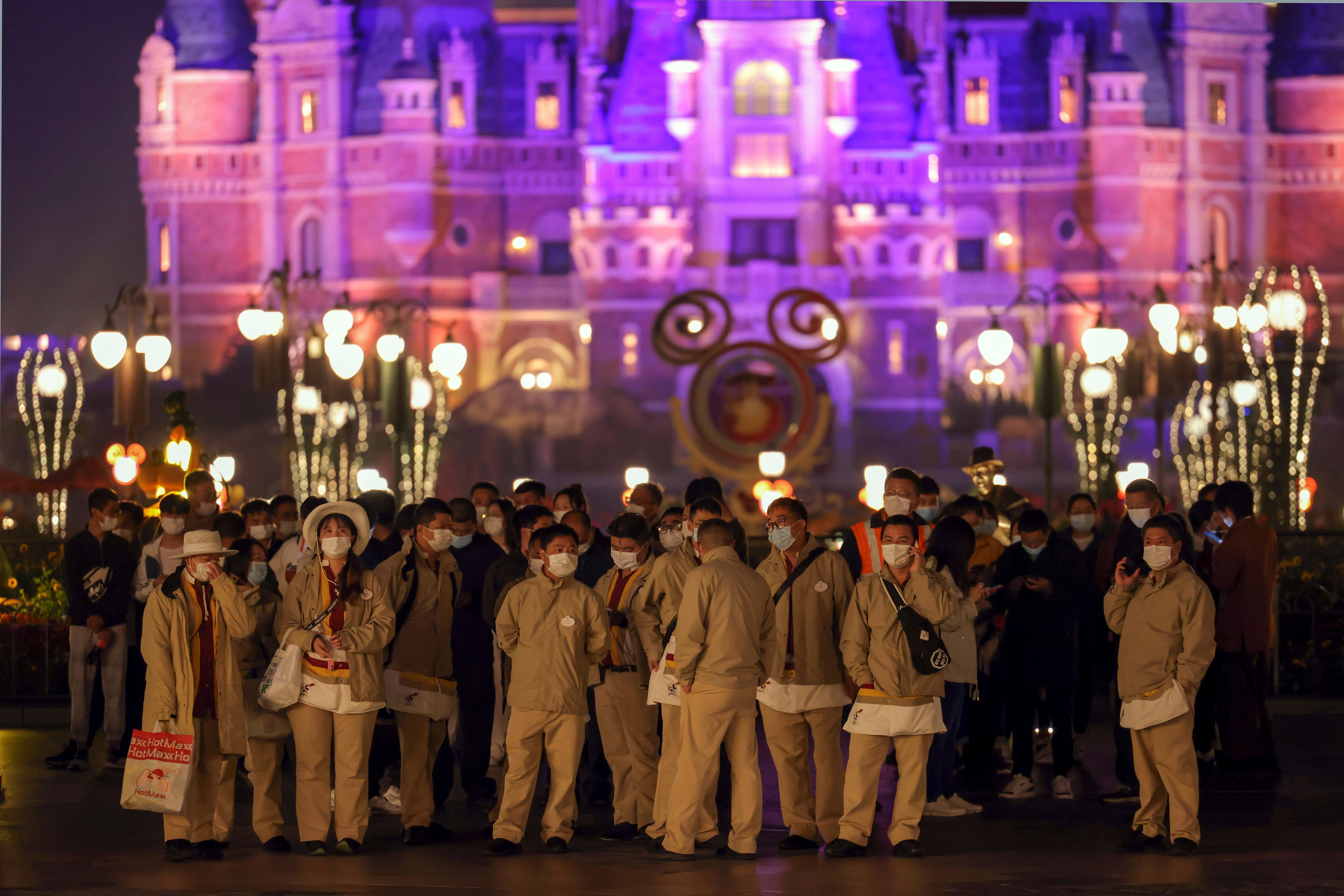 Disneyland employees gather to wait for their Covid-19 tests at the Shanghai Disney Resort