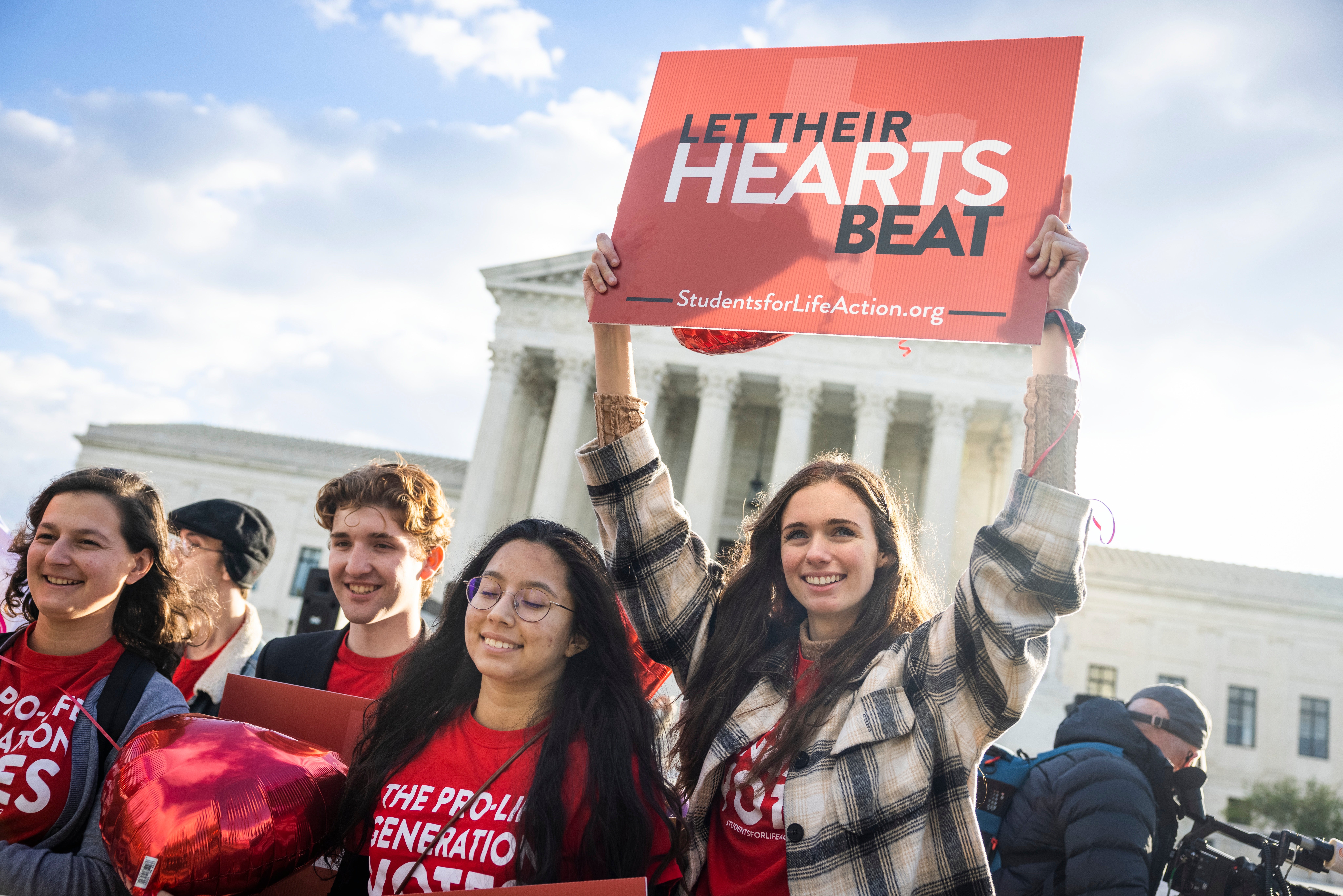 Anti-abortion protesters gather outside the US Supreme Court as the high court hears arguments in two challenges to a Texas law that bans most abortions in Washington, DC