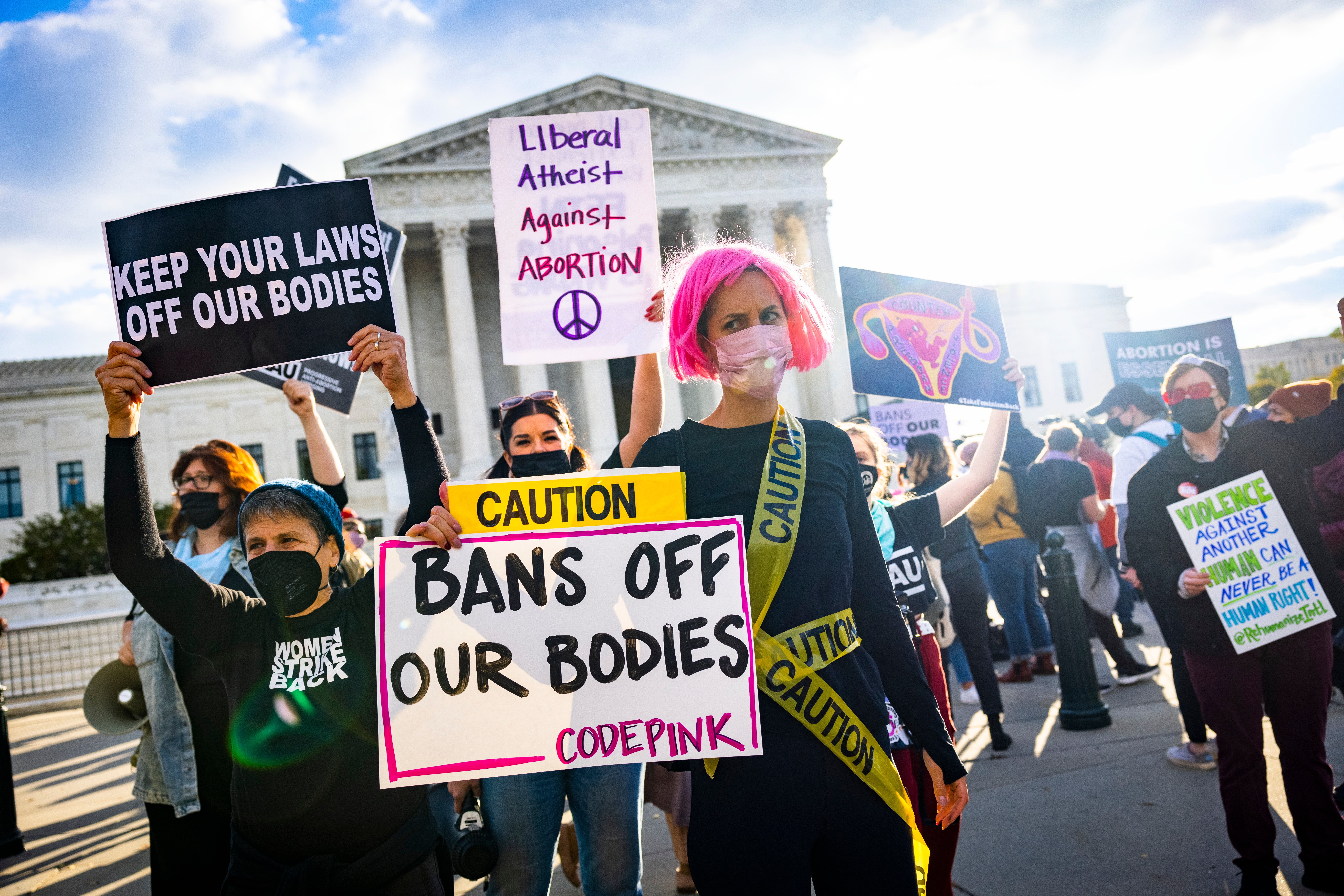 Abortion supporters and protesters gather outside the US Supreme Court as the high court hears arguments in two challenges to a Texas law that bans most abortions in Washington, DC