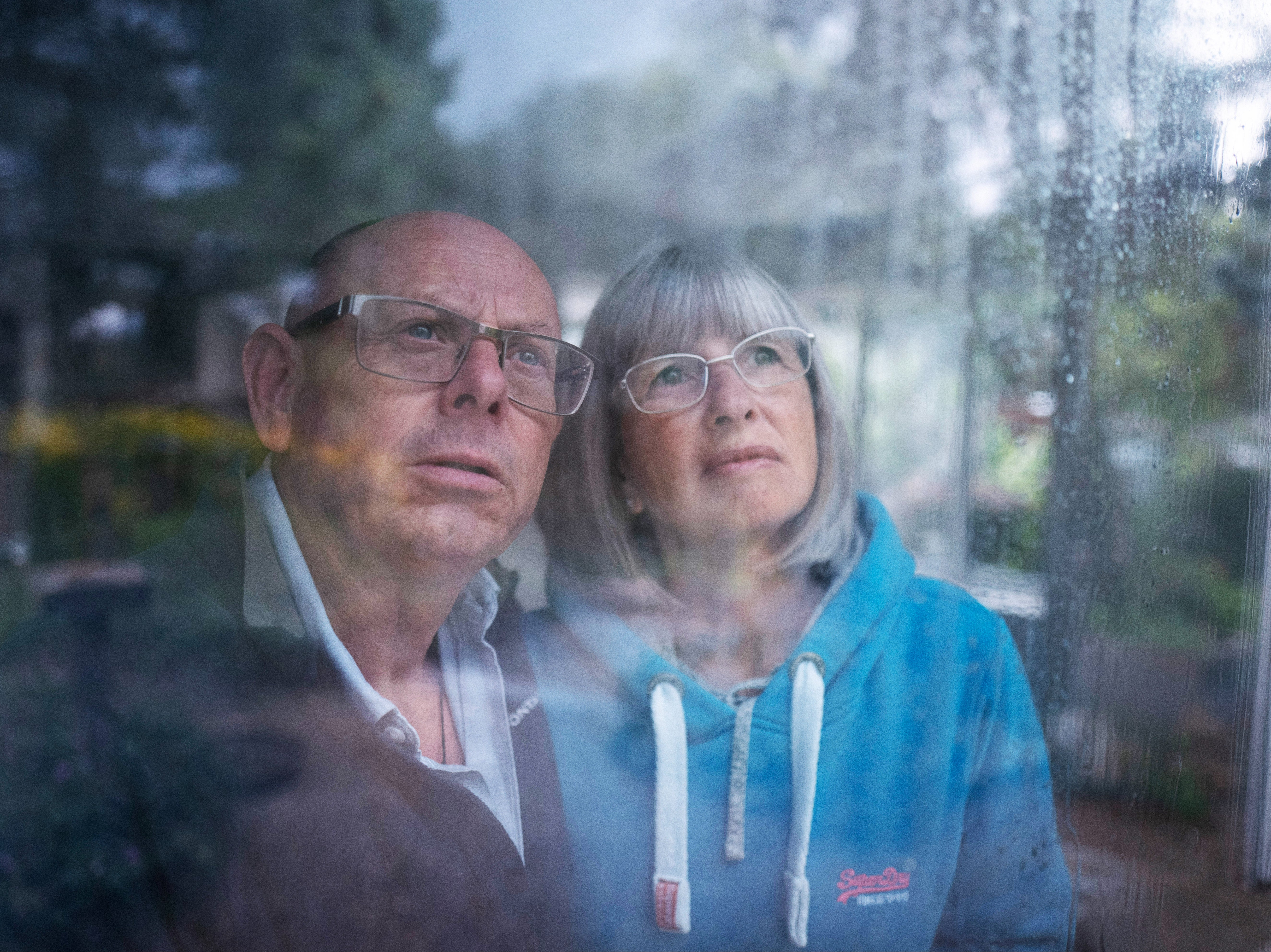 First-time flood victims Roger and Linda Walsh watch the rain from their home in Rendenhall, Norfolk
