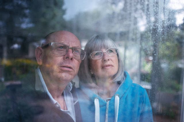 <p>First-time flood victims Roger and Linda  Walsh watch the rain from their home in Rendenhall, Norfolk</p>