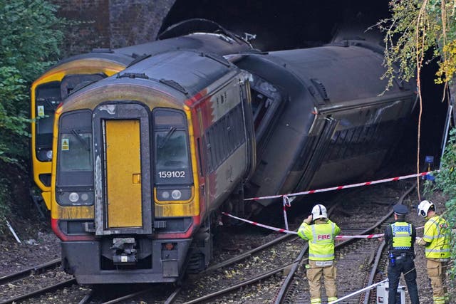 <p>Police and firefighters at the scene of a crash involving two trains near the Fisherton Tunnel between Andover and Salisbury in Wiltshire</p>