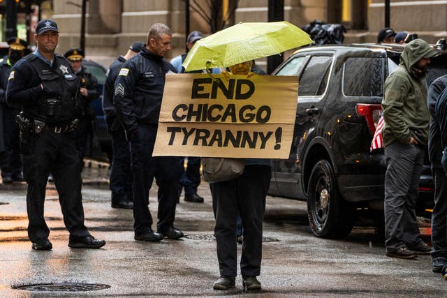 <p>Fraternal Order of Police Lodge 7 members and their supporters protest against Covid-19 vaccine mandates outside City Hall before a Chicago City Council meeting, on 25 October, 2021</p>