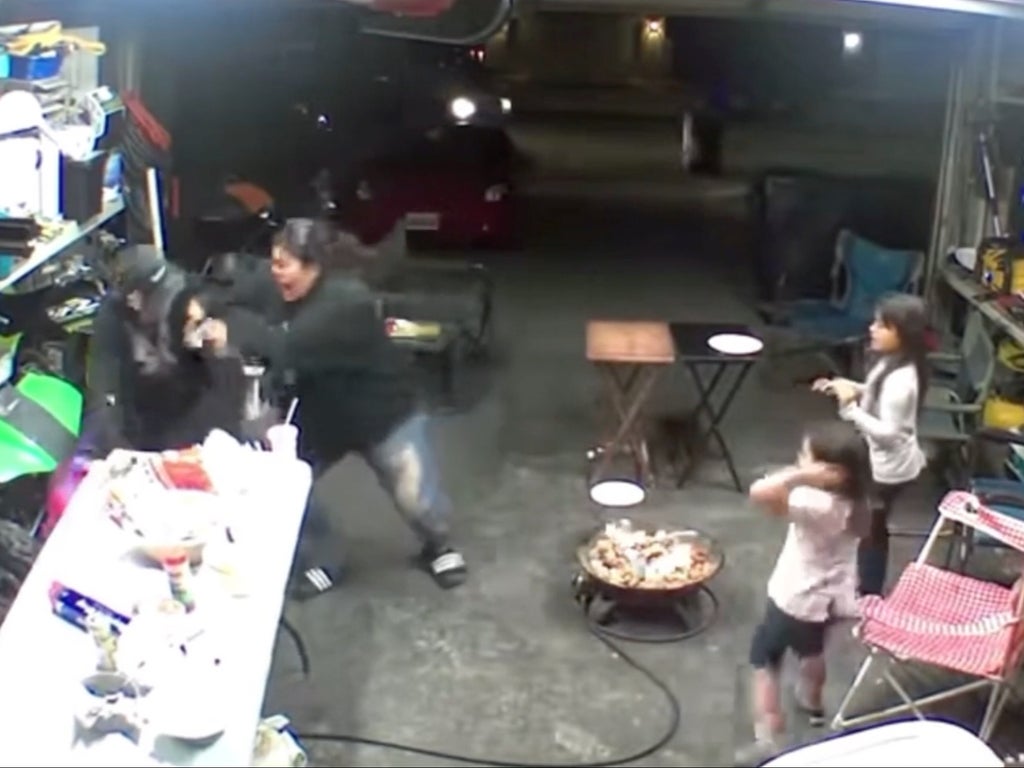 Mother filmed fighting off intruder as he ran toward her children