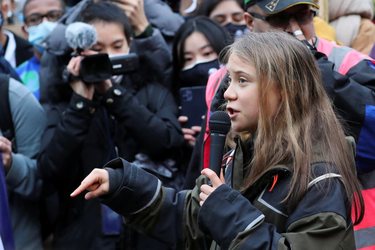 ‘We’re already in a living hell’: Greta Thunberg joins young climate activists outside Cop26 to demand faster action