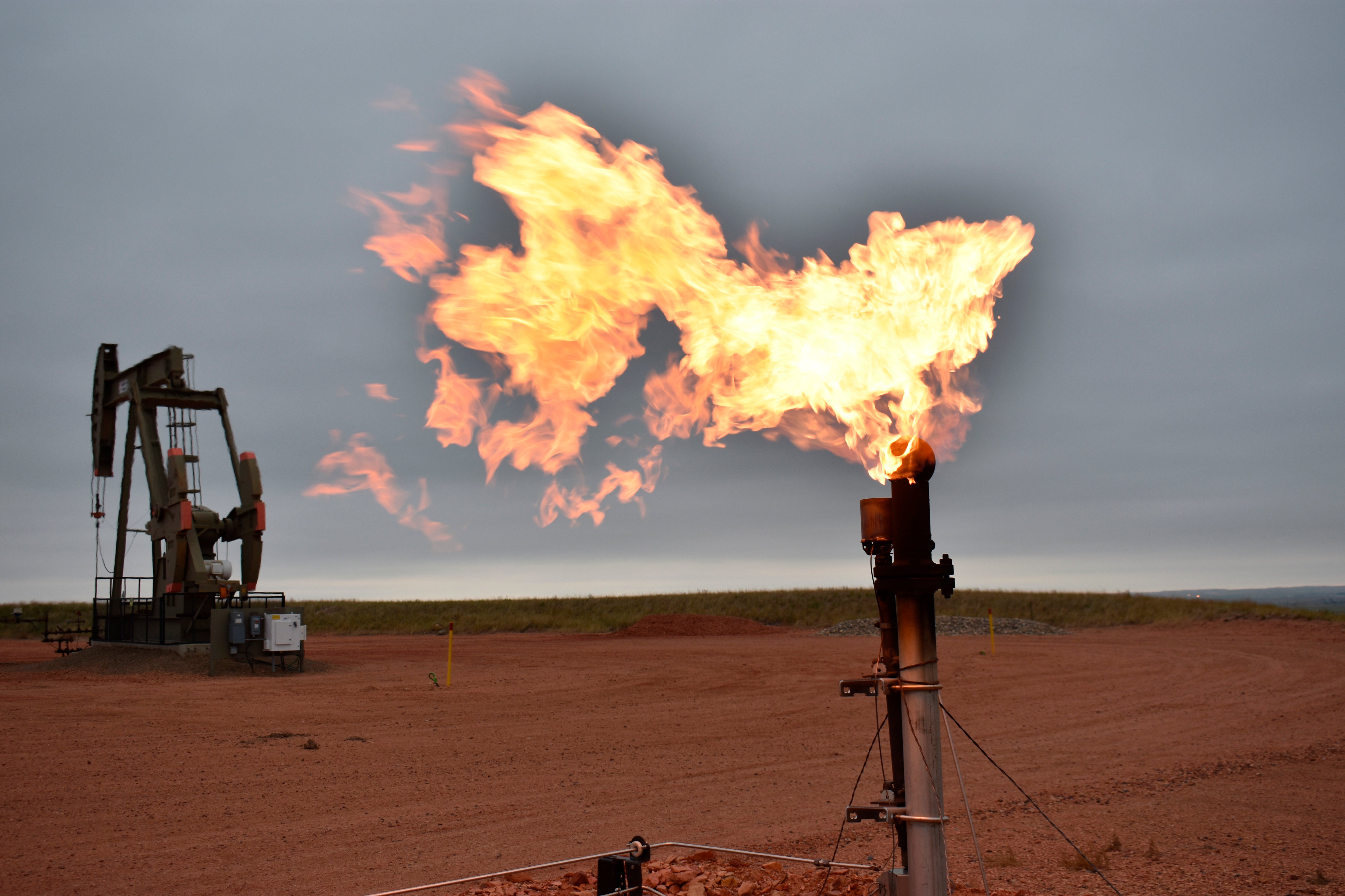 File photo: A flare burns natural gas at an oil well on 26 August in Watford City, North Dakota