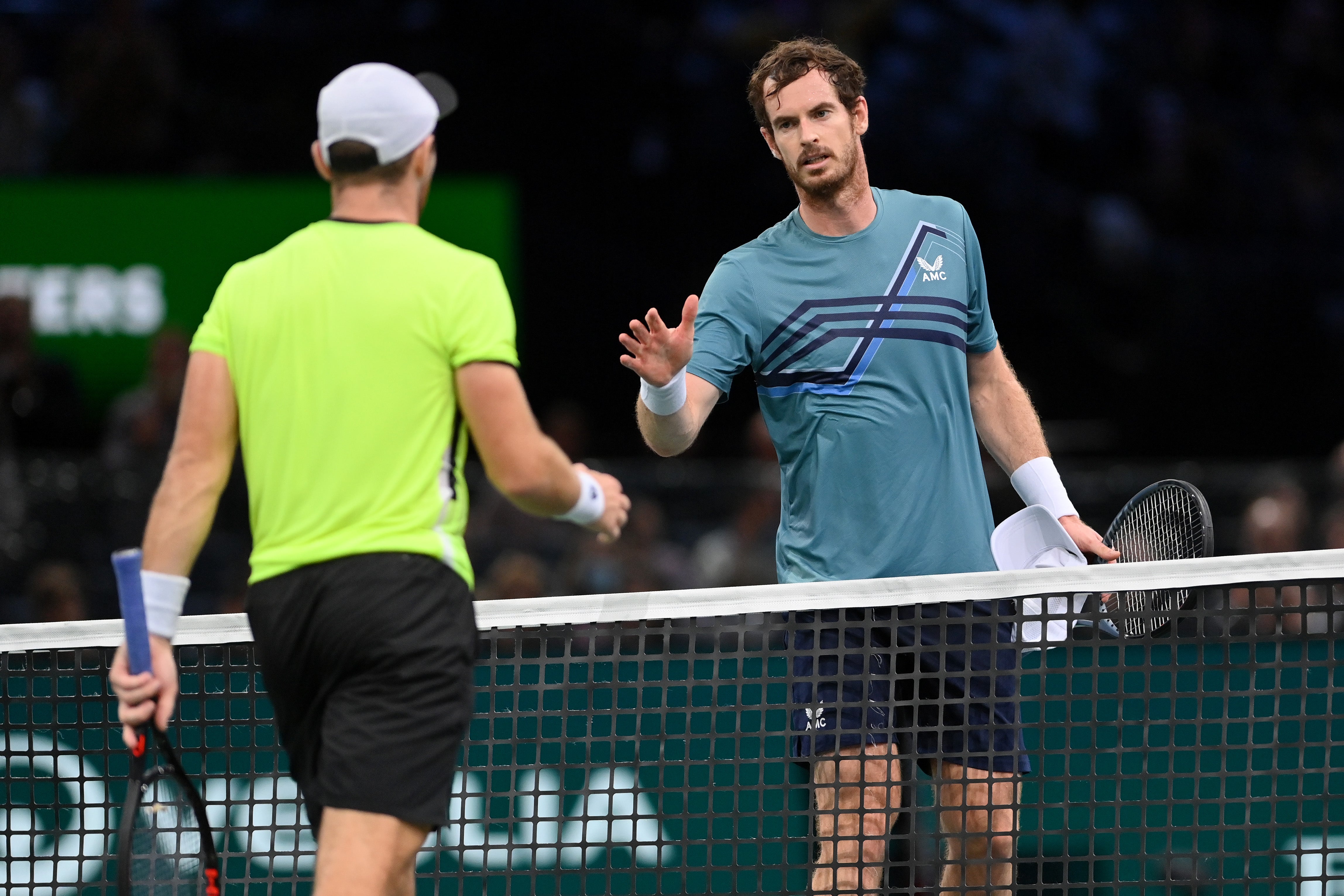 Andy Murray shakes hands at the net after losing to Dominik Koepfer