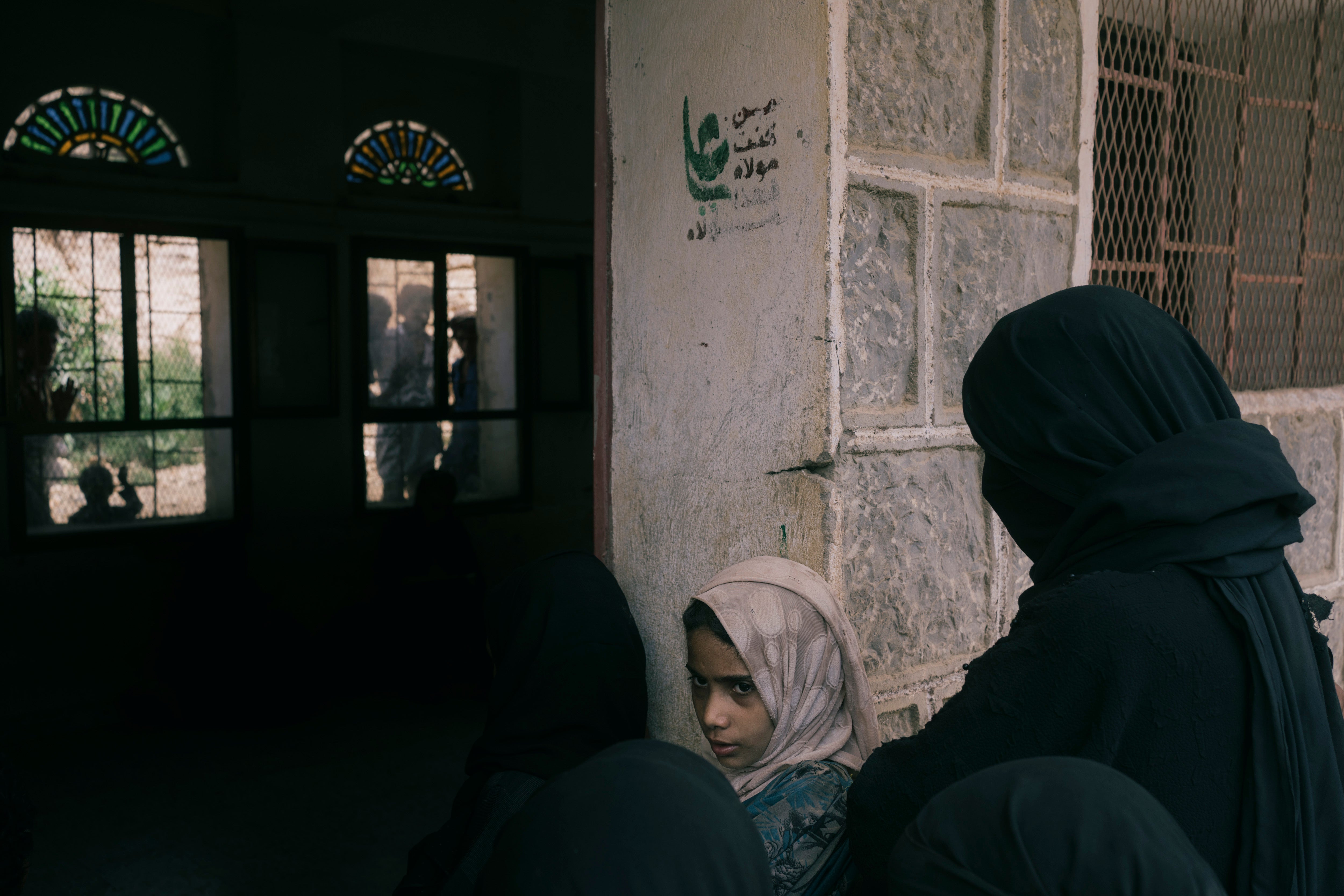 Women from several villages gather at a school in Moulis, where food is distributed by the World Food Program