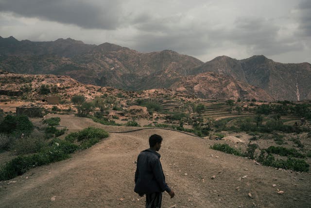<p>Mohammed Fulait Ahmed walks among the hills of his village, Moulis, in Yemen’s Maghrabah district</p>