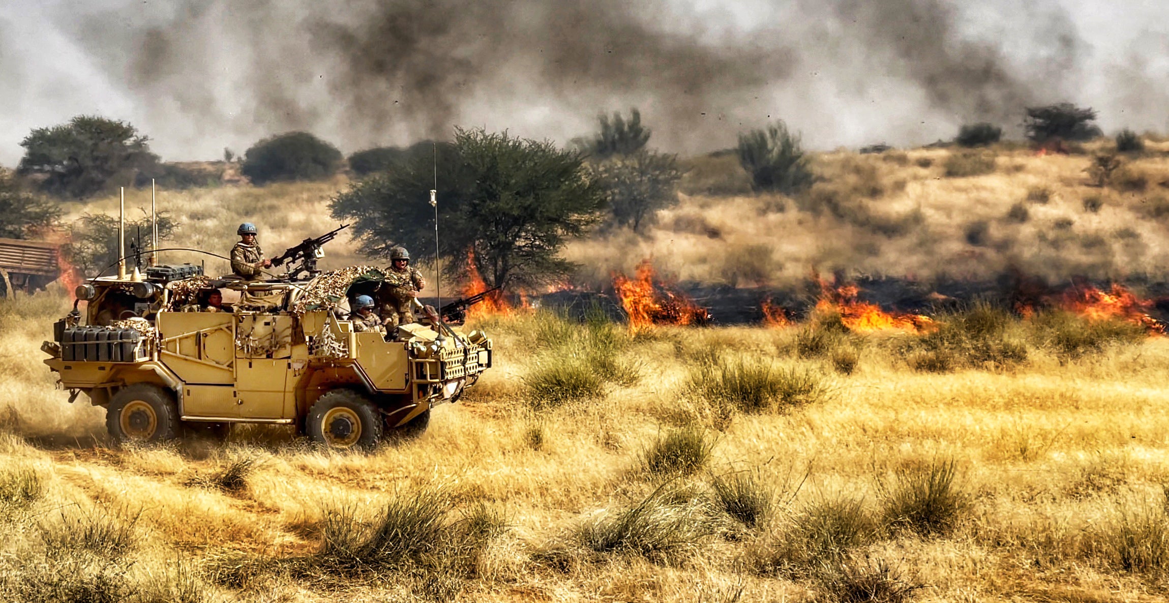 A Jackal reconnaissance armoured vehicle from the Queen’s Dragoon Guards fleeing bush fire on patrol