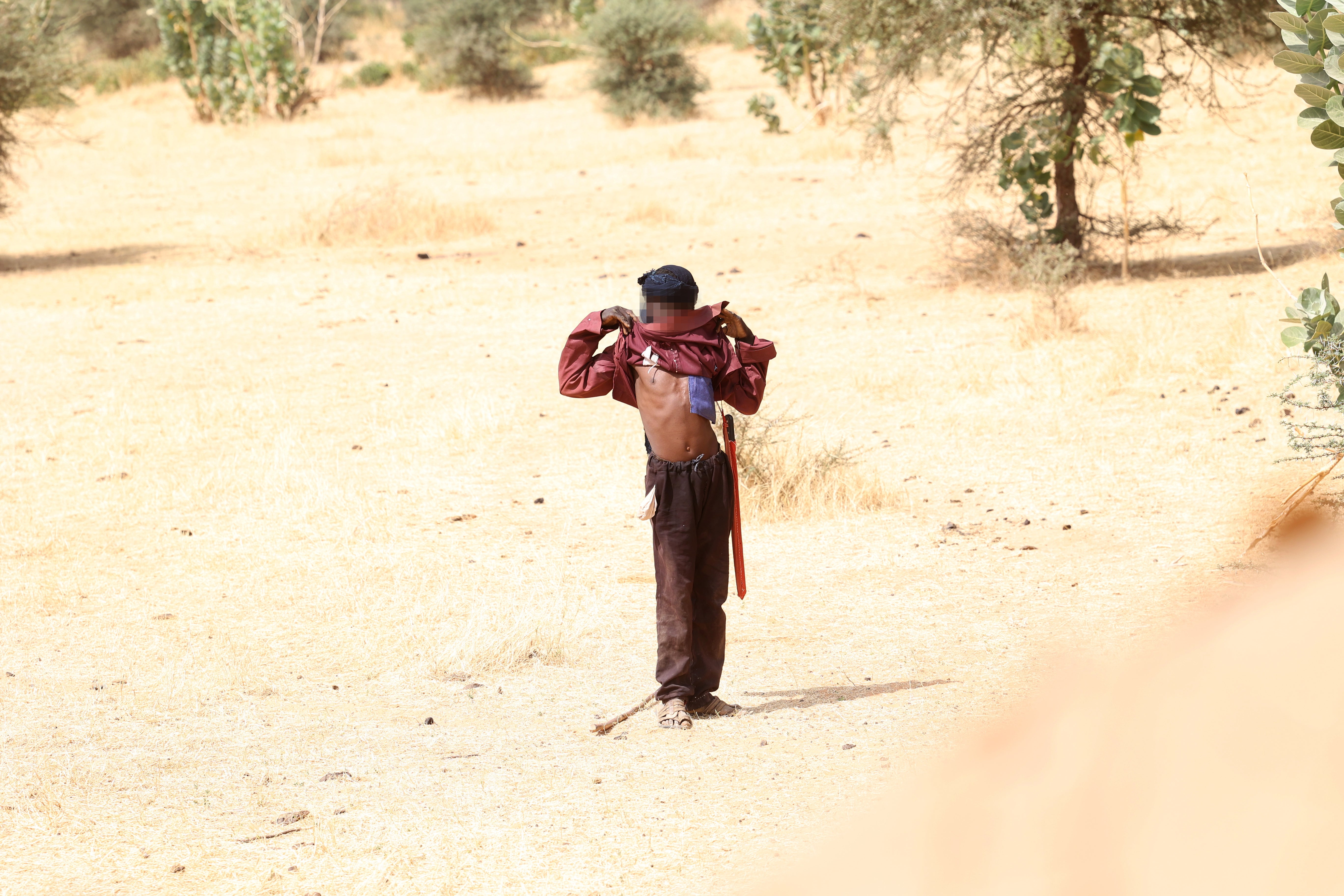 Troops from 4th Troop C Squadron, Queen’s Dragoon Guards tell a suspicious man to lift his shirt to show he is unarmed