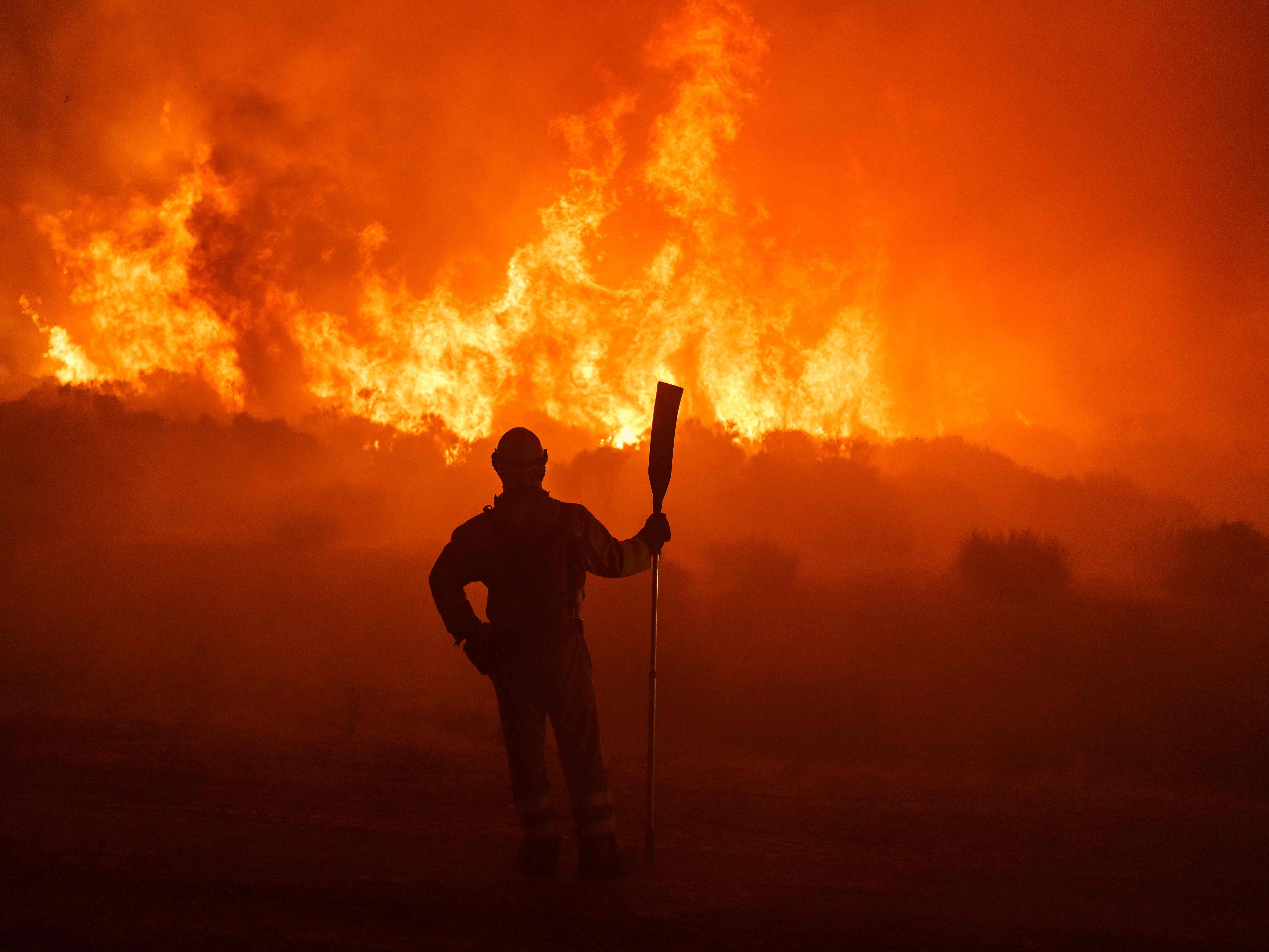 <p>Firefighters operate at the site of a wildfire between Navalacruz and Riofrio near Avila, central Spain</p>