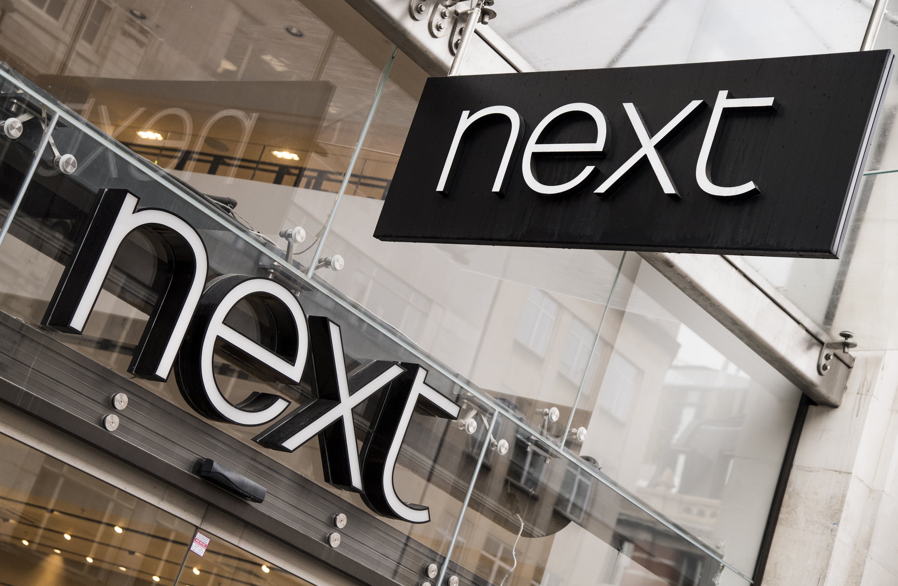Retail giant Next has said stock availability has improved but remains challenging (PA)