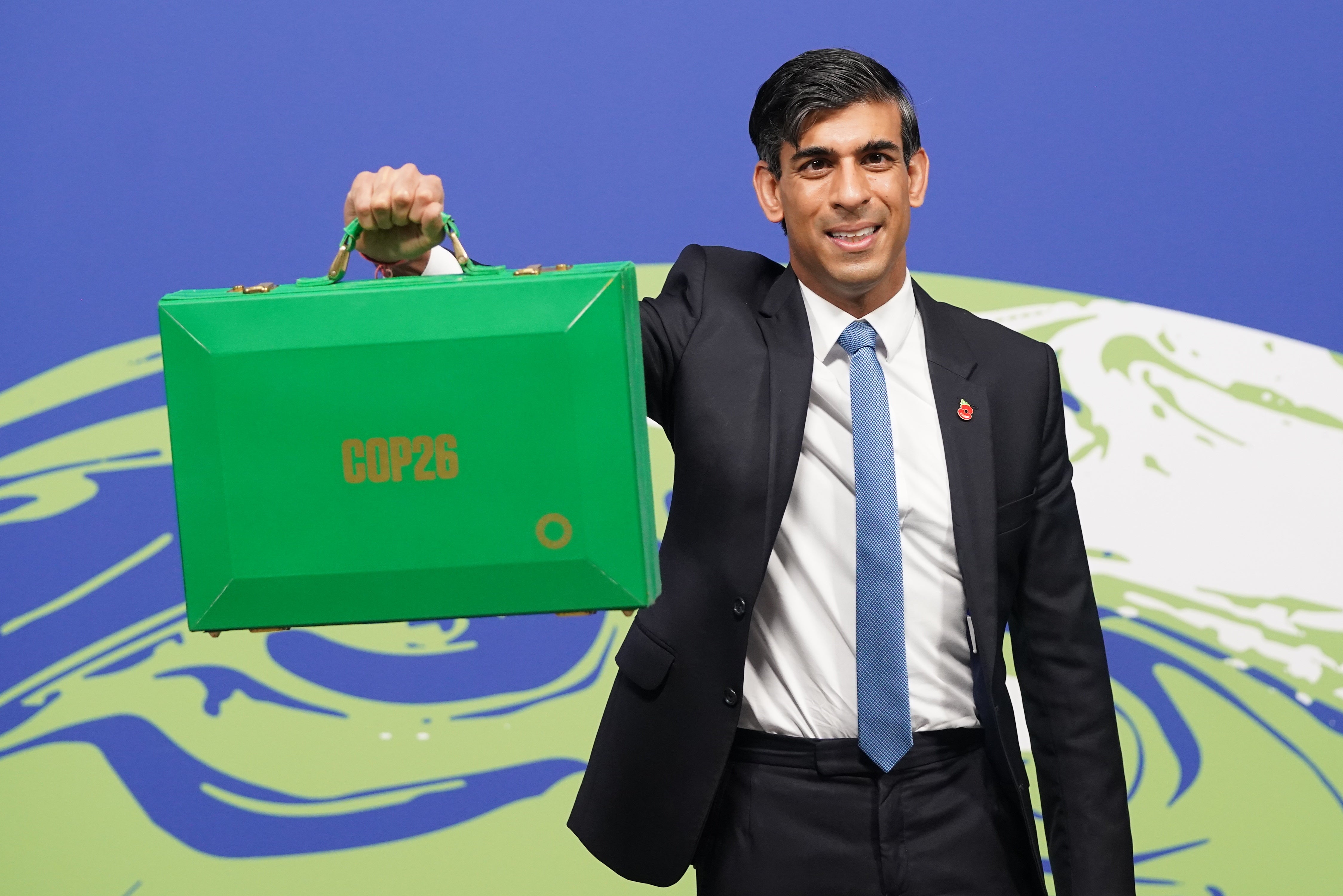 Chancellor Rishi Sunak holds his Green Box at the Cop26 summit in Glasgow (Stefan Rousseau/PA)