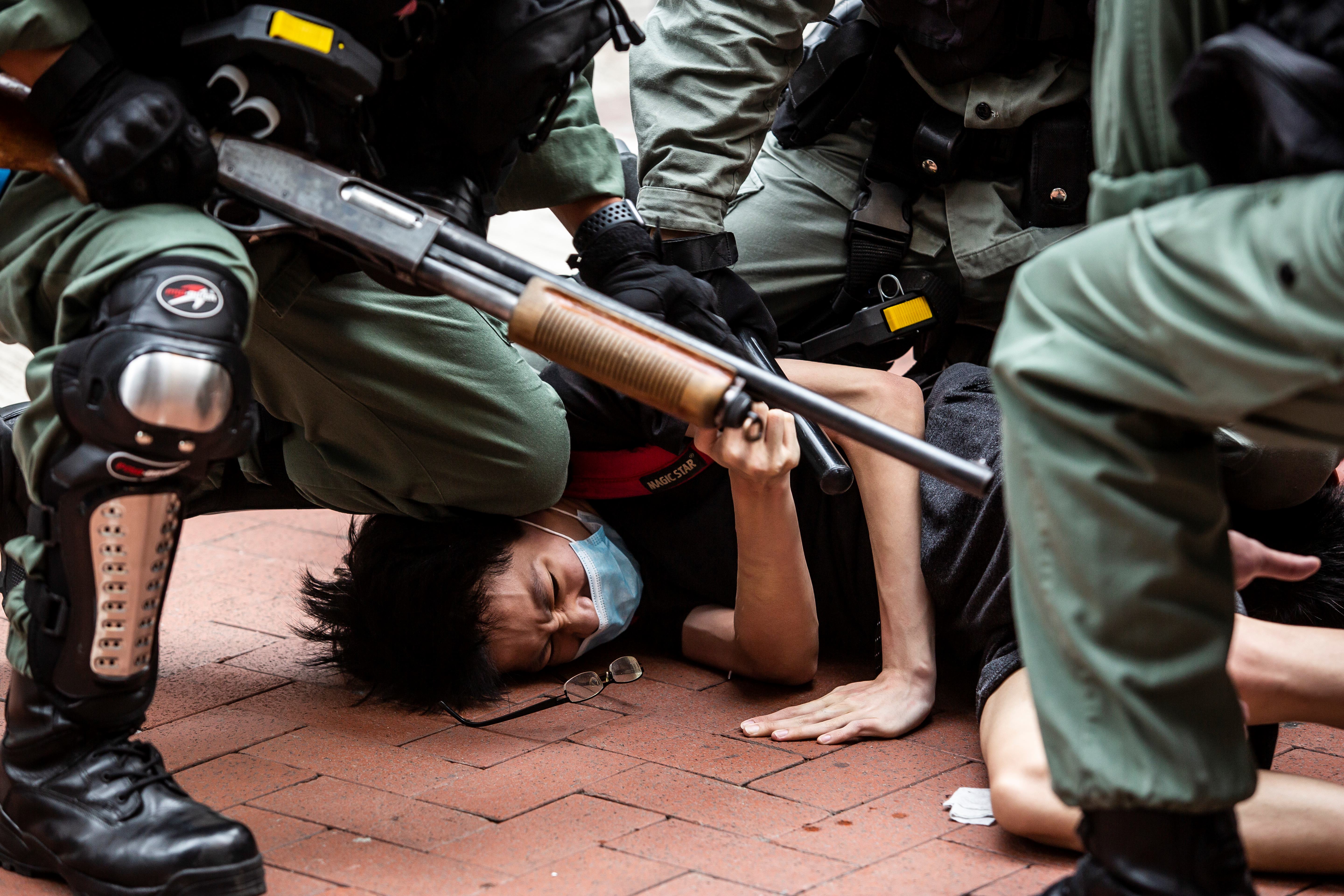 Pro-democracy protesters are arrested by police in the Causeway Bay district of Hong Kong on 24 May 2020