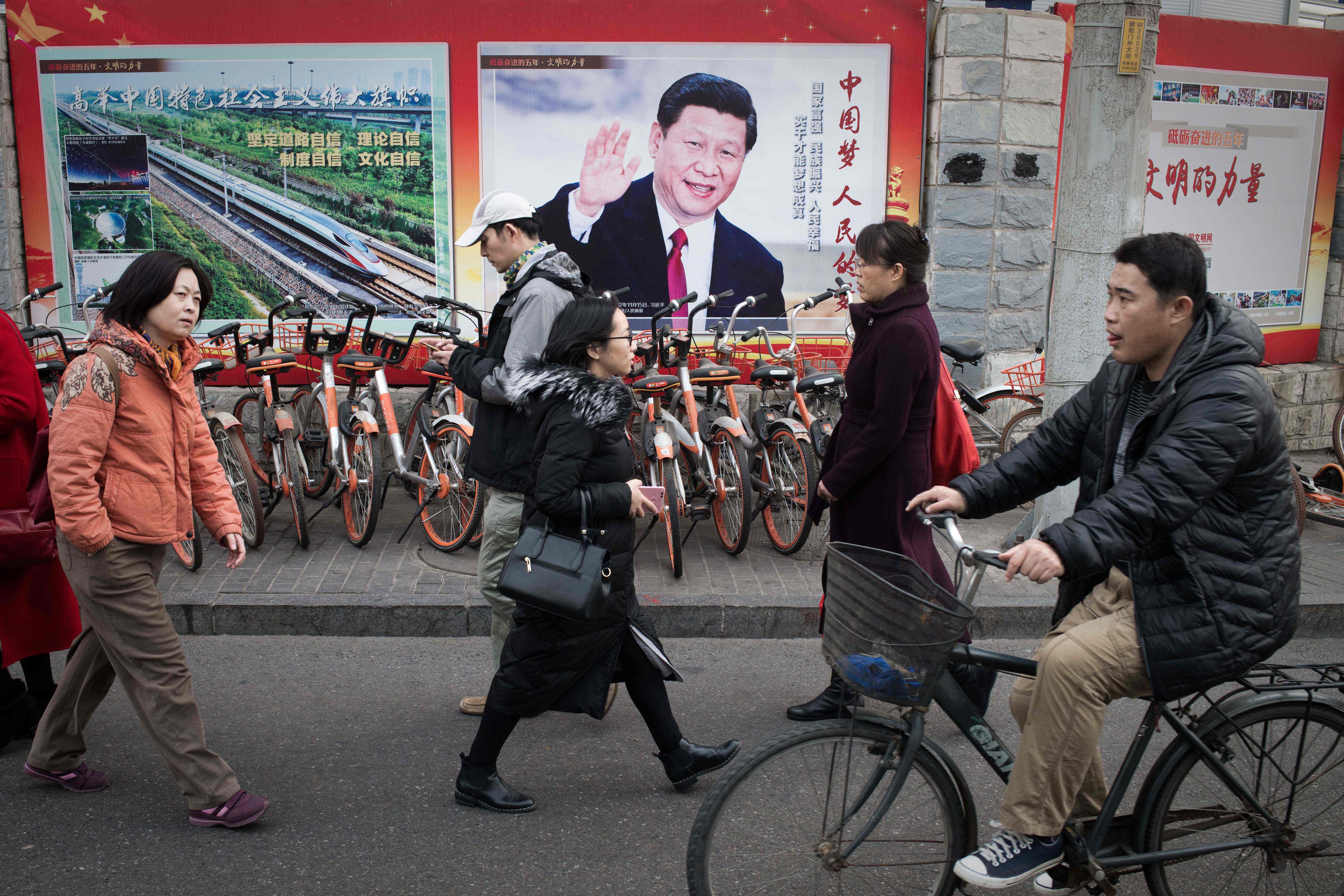 File: A propaganda poster showing China’s President Xi Jinping is pictured on a wall in Beijing