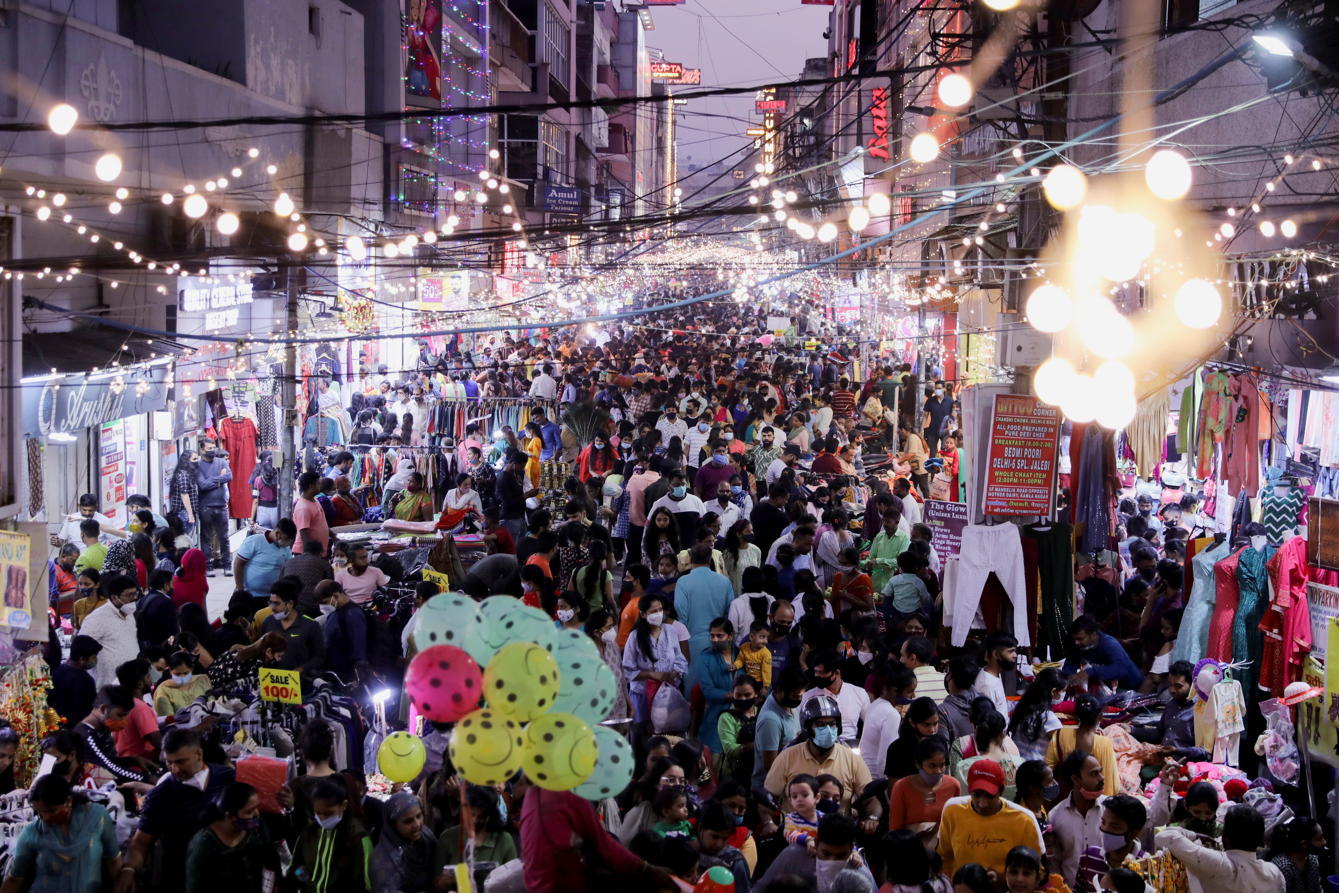 People shop at a crowded market ahead of Diwali in Delhi