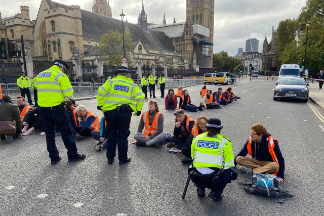 <p>Insulate Britain have glued themselves to the road outside parliament</p>