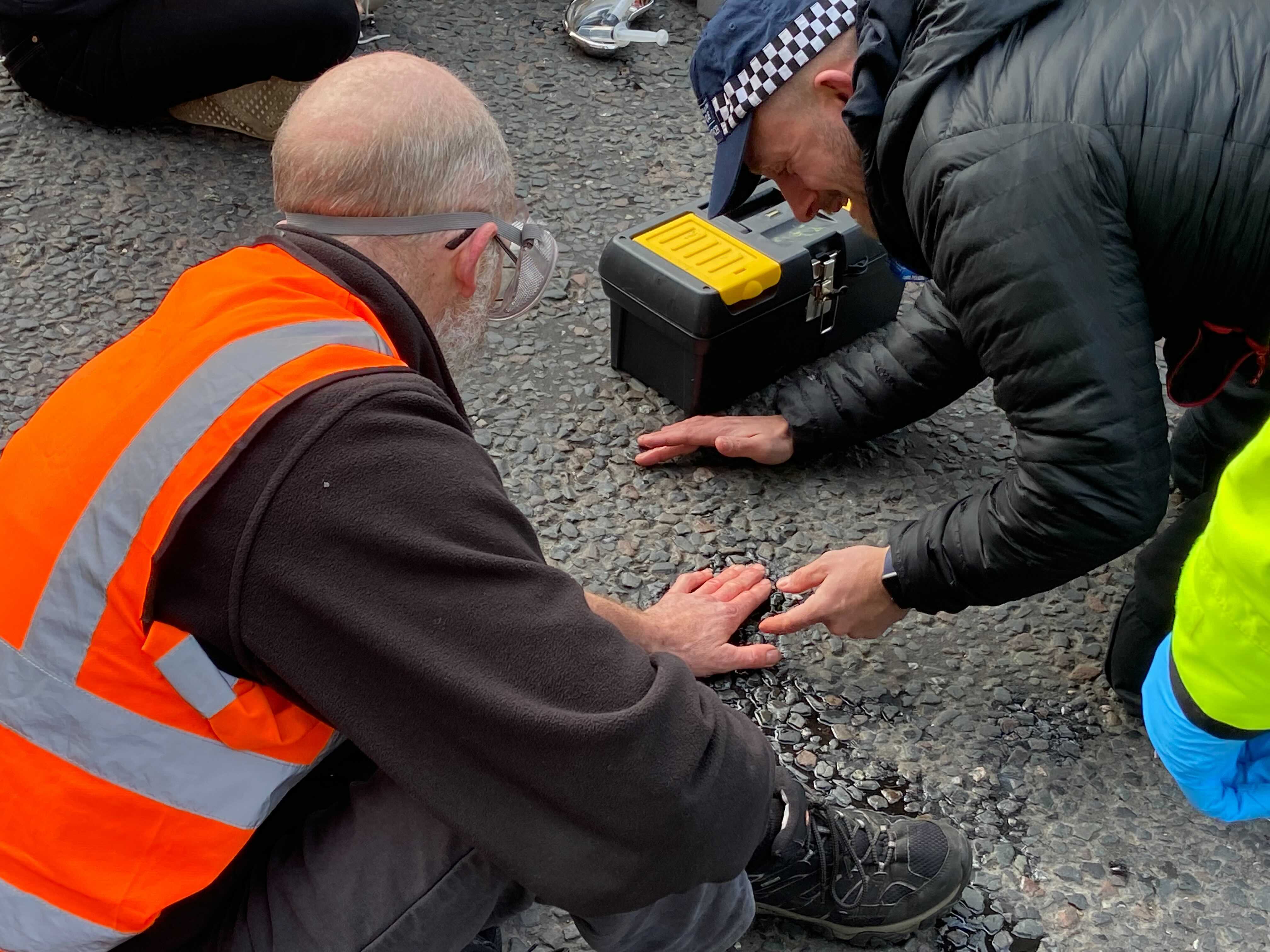 Insulate Britain activists glue themselves to ground outside parliament