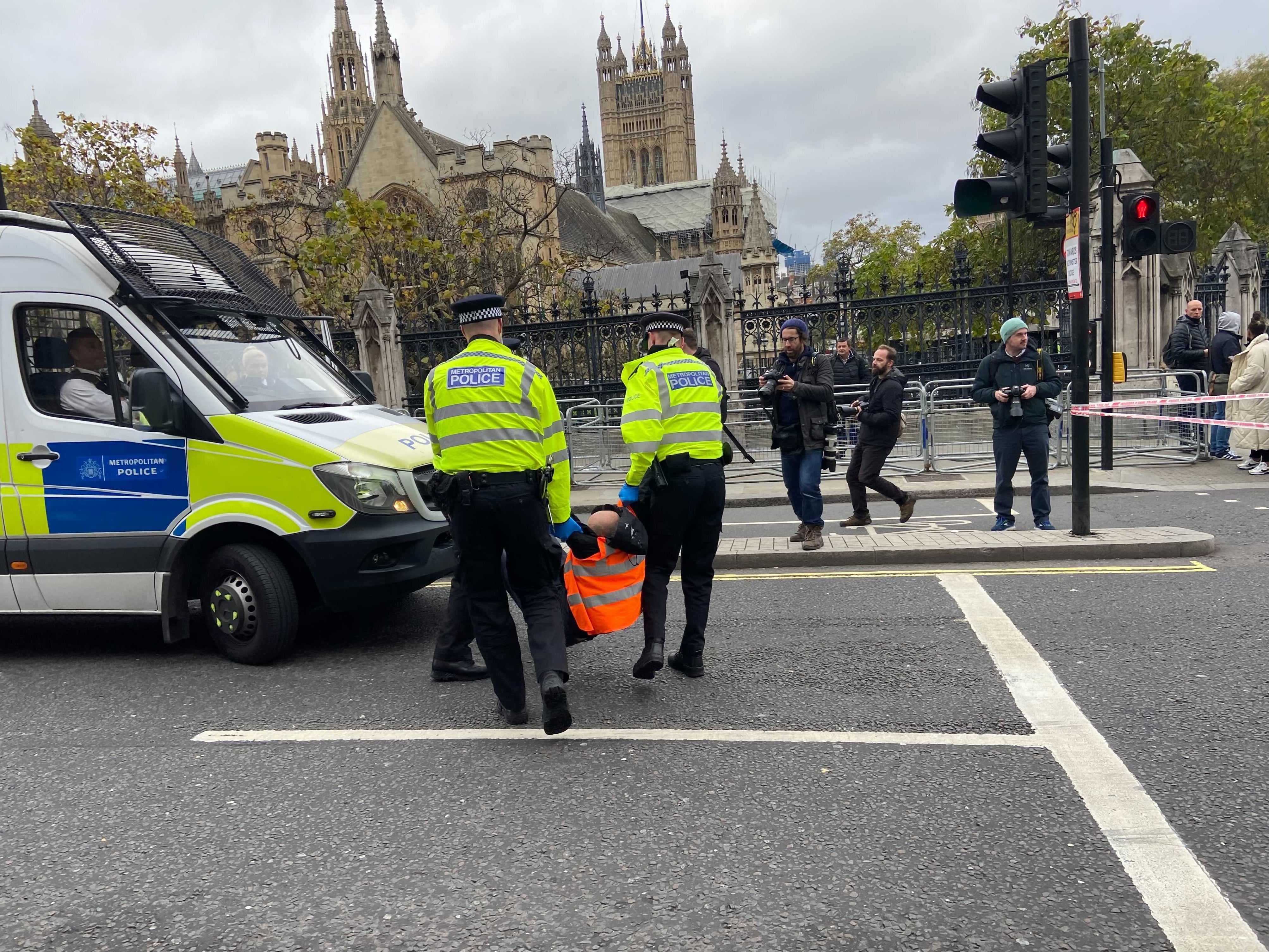 Police carry a protester away during the parliament demonstration