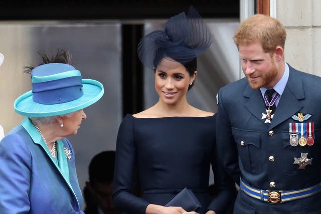 <p>Queen Elizabeth II, Meghan, Duchess of Sussex, Prince Harry, Duke of Sussex watch the RAF flypast on the balcony of Buckingham Palace on July 10, 2018</p>