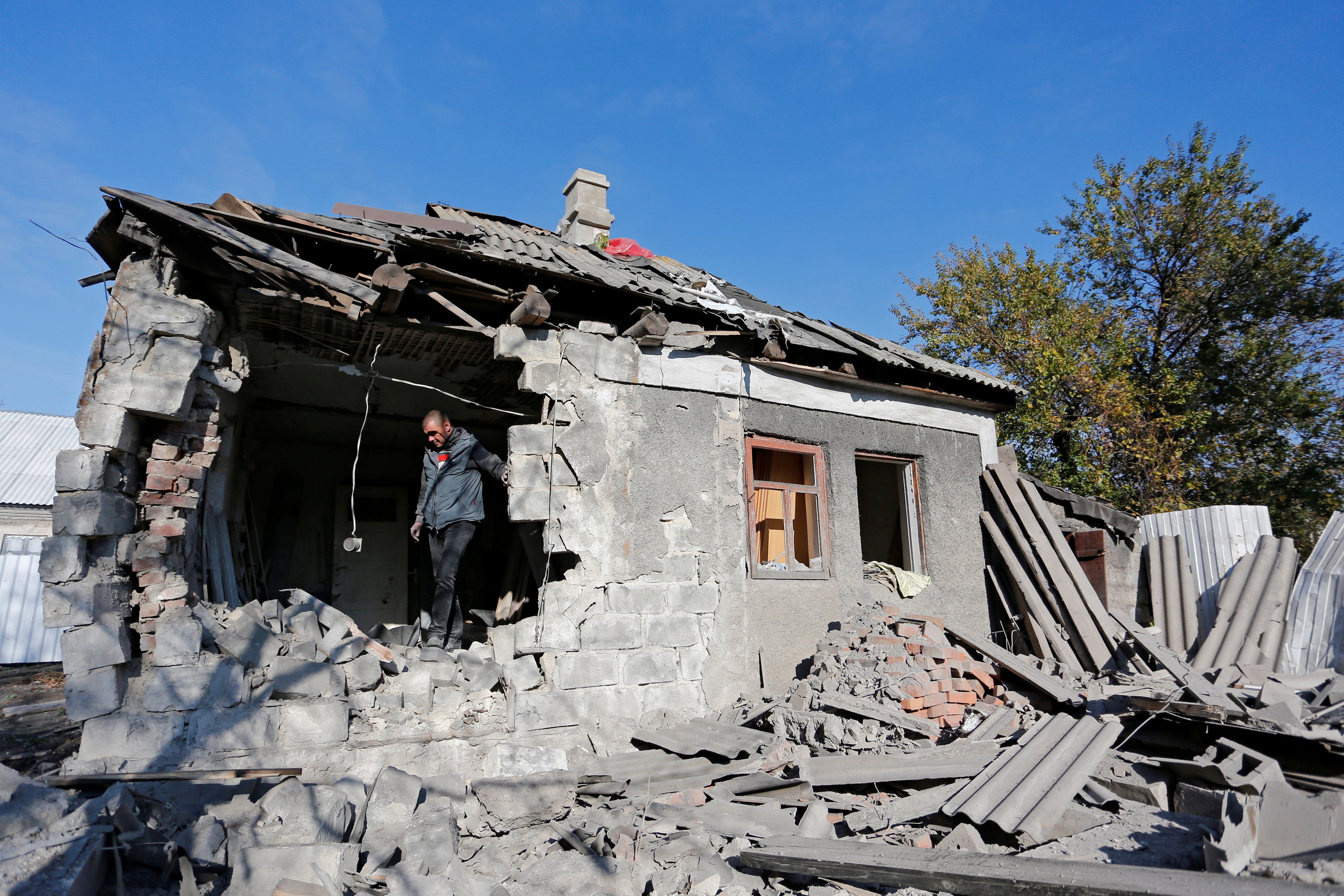 Local resident Pavel is seen inside his house, which locals said was damaged during recent shelling, on the outskirts of the rebel-controlled city of Donetsk in October