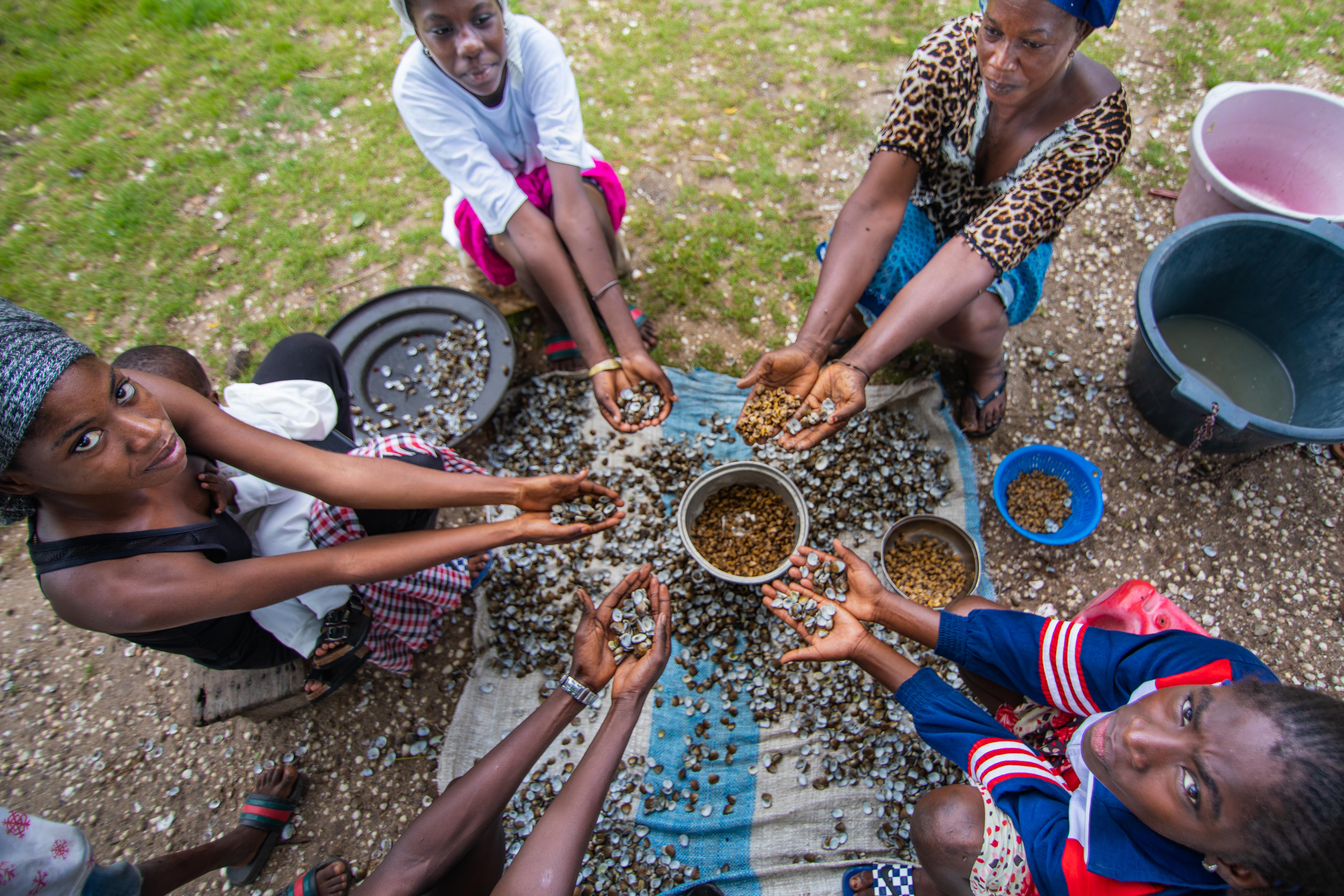 Women hold cockles at the Woman’s House