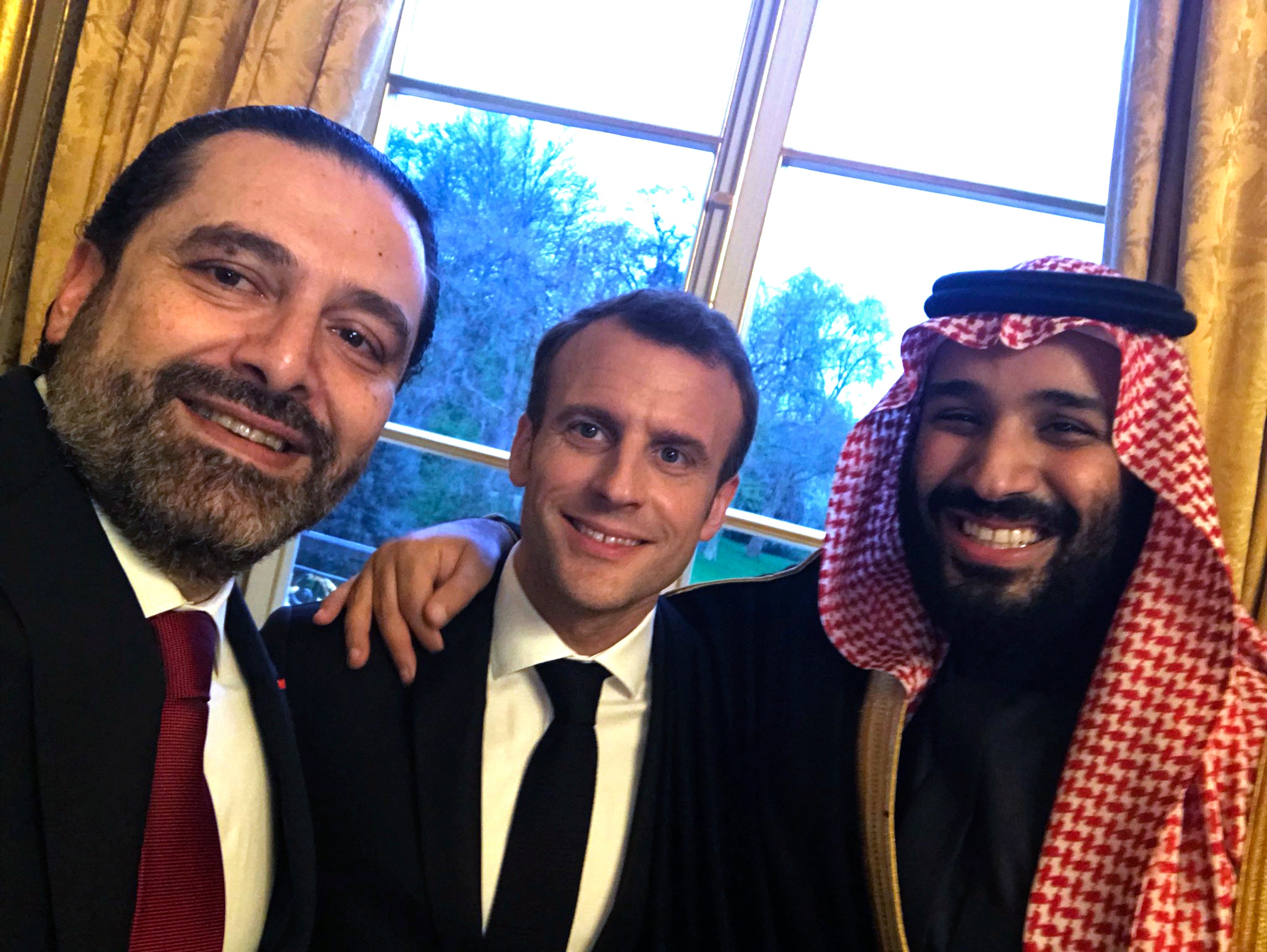 This photo released on the official twitter page of Lebanese Prime Minister Saad Hariri in April 2018, shows Hariri, left, taking a selfie photo with French President Emmanuel Macron, center, and Saudi Arabia's Crown Prince Mohammed bin Salman, right, in the King George V Hotel, in Paris, France