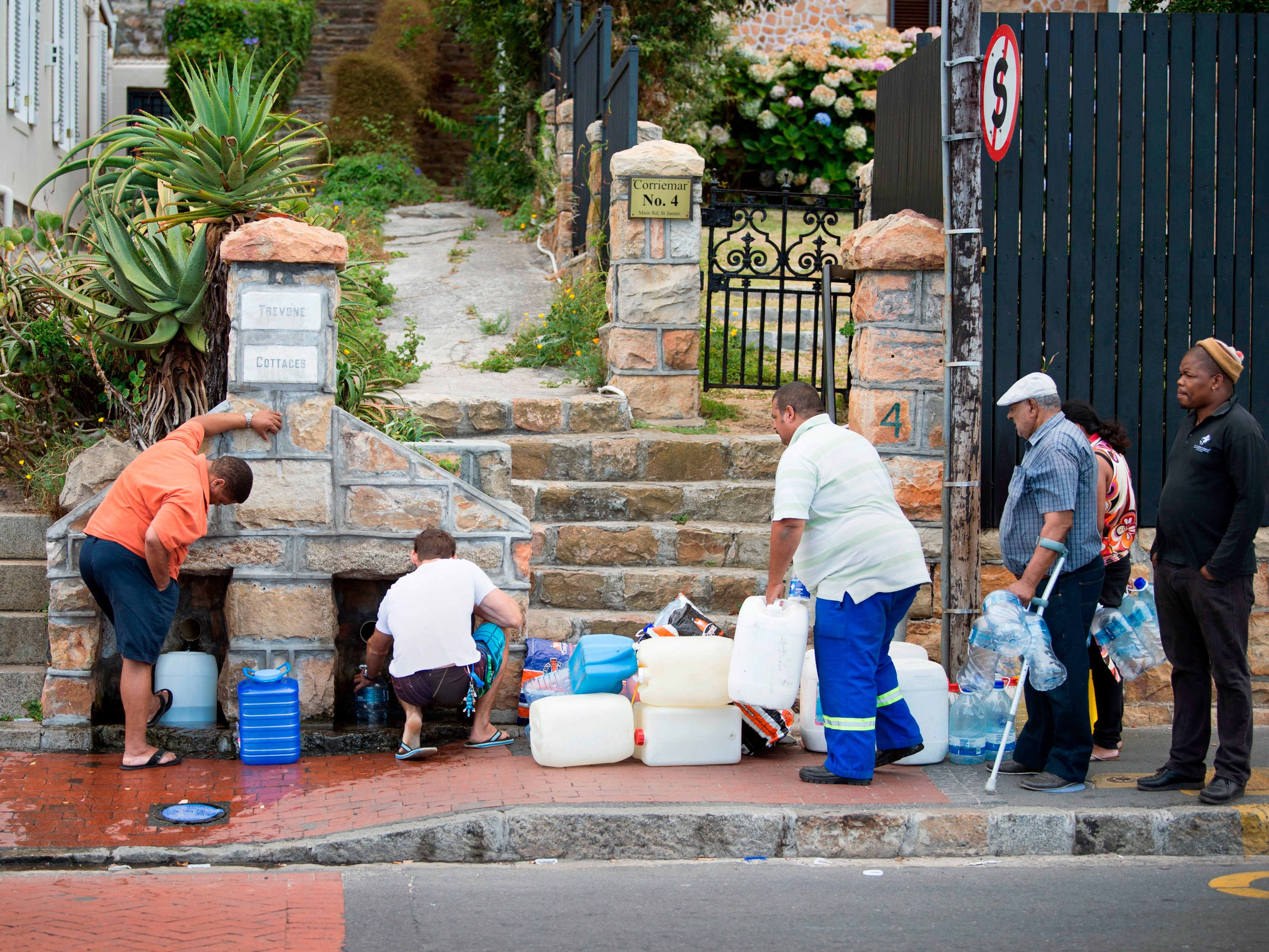 Locals queue for drinking water in Cape Town during the drought in January 2018