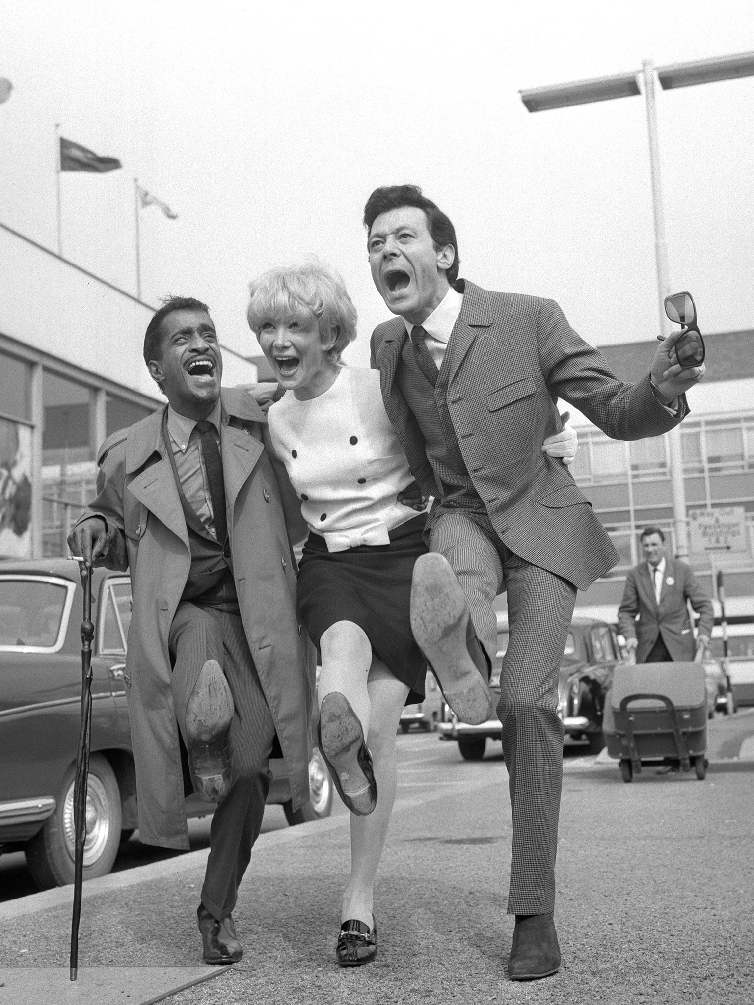 Blair with his younger sister Joyce, an actress, and Sammy Davis Jr at Heathrow Airport in 1966