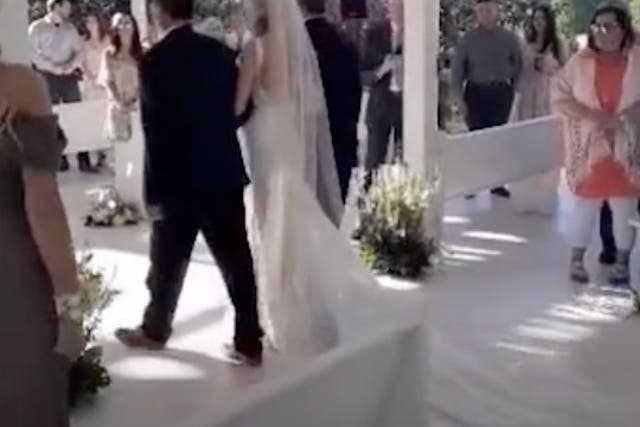 <p>Bride's father stops walk down the aisle to include her stepfather as well</p>