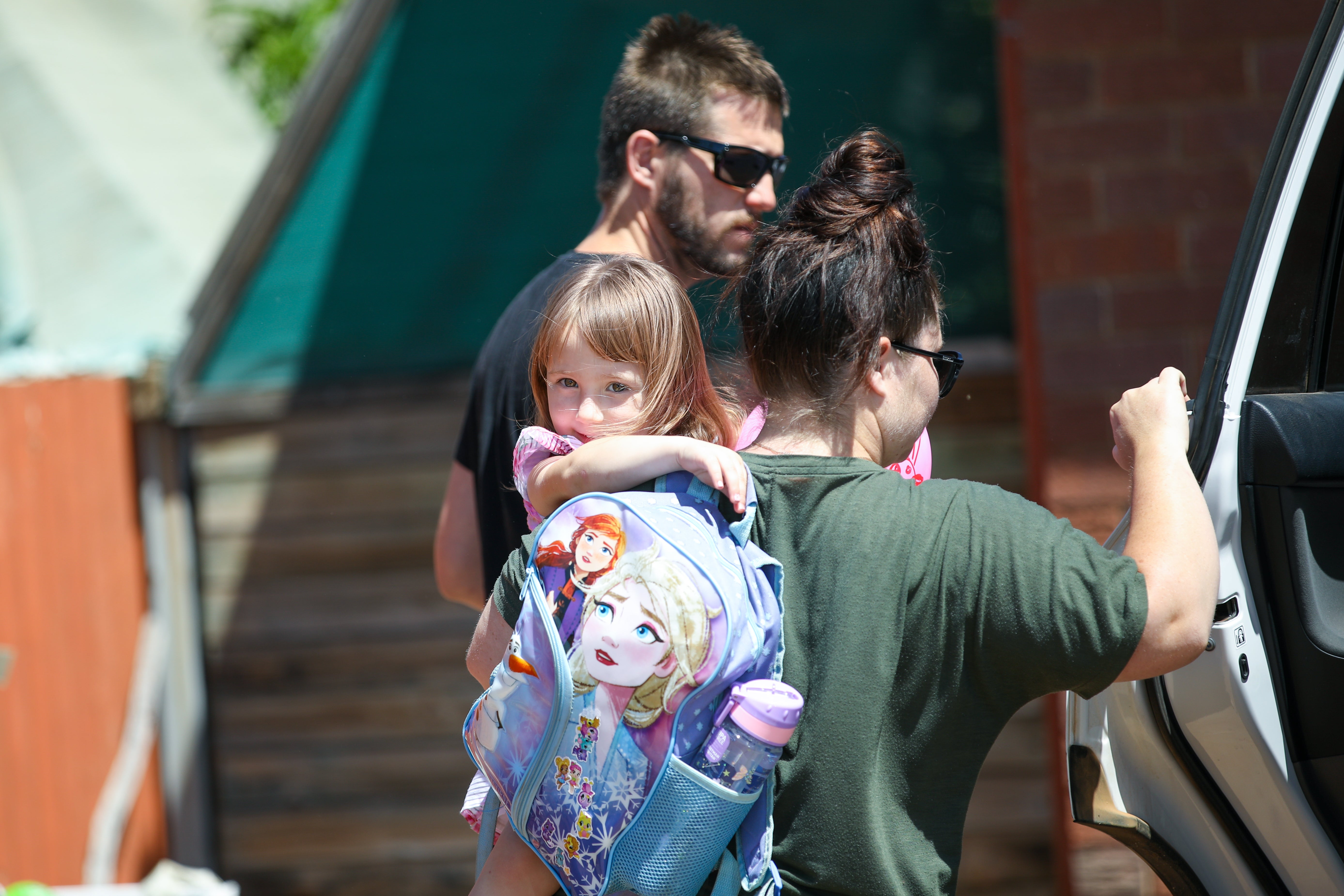 Cleo Smith is carried inside a friend's house by her mother on 4 November 2021 in Carnarvon, Australia