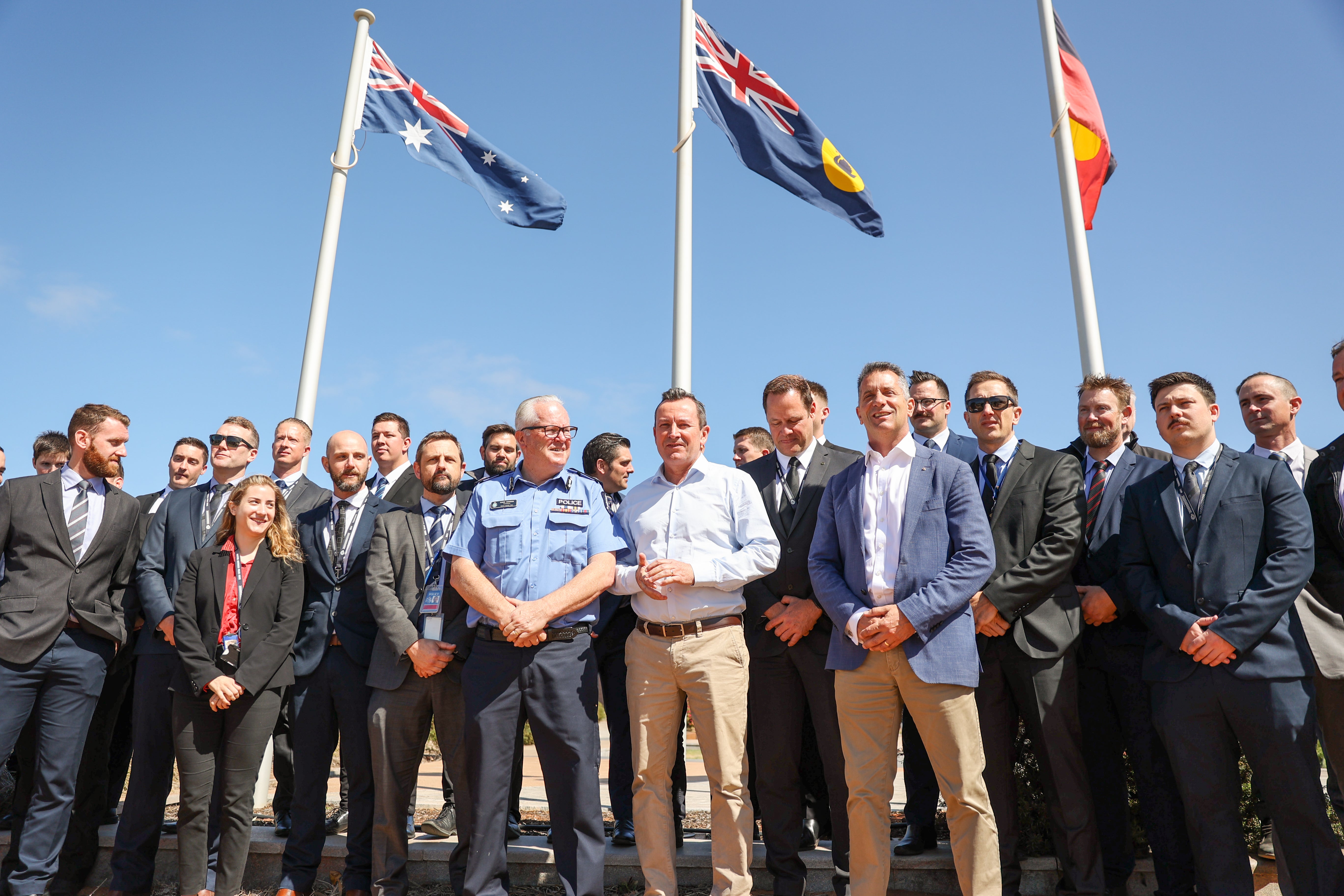 Western Australia Premiere Mark McGowan poses with police officers after speaking at a press conference in front of the Carnarvon Police Station on 4 November 2021 in Carnarvon, Australia