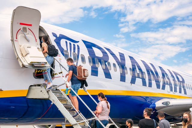 <p>Passengers boarding a Ryanair flight</p>