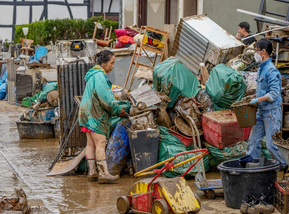 <p>Many were forced to throw out not just rubbish, but also their possessions as a result of the floods </p>