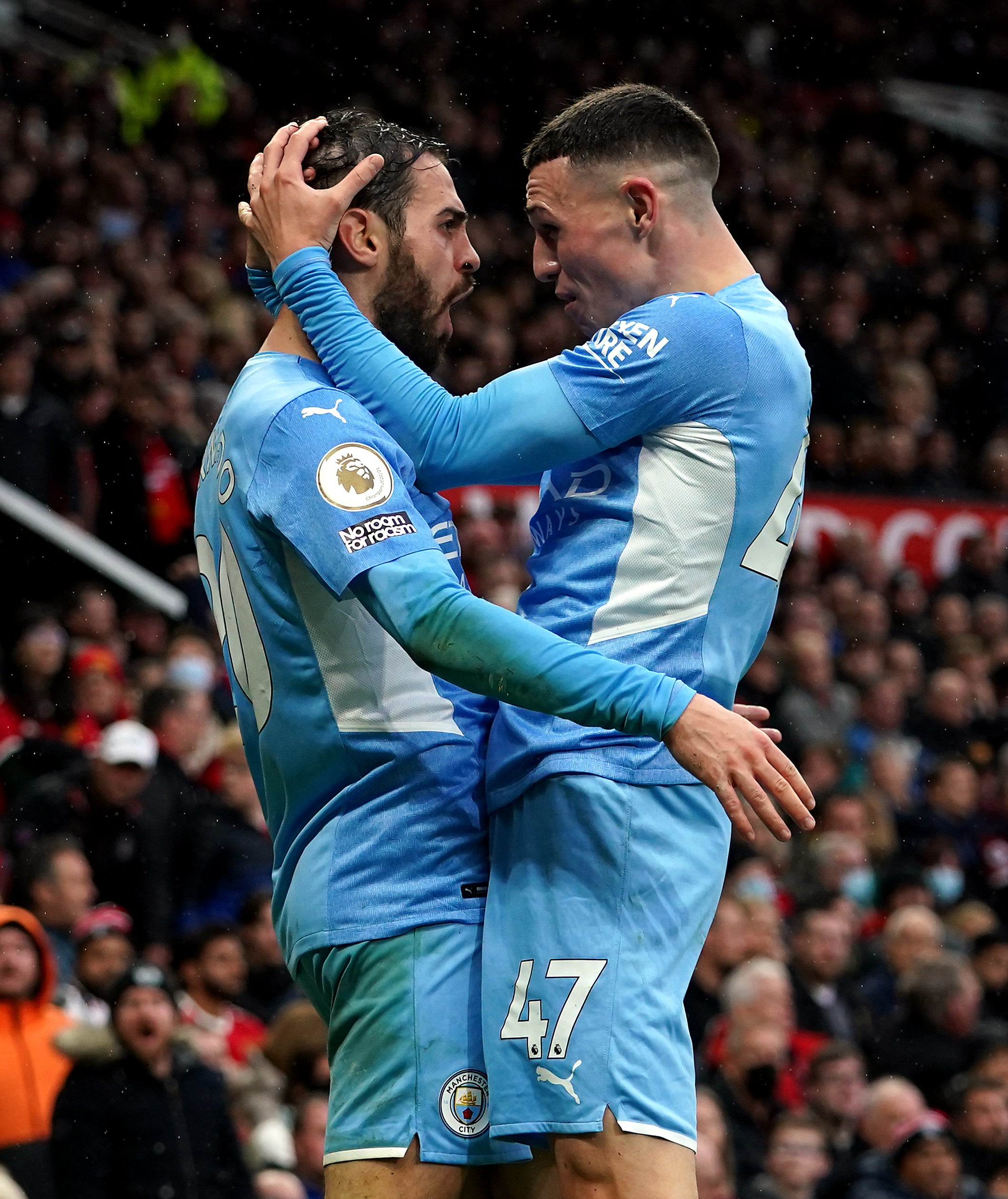 Bernardo Silva celebrates with Phil Foden after scoring Manchester City’s second goal at Old Trafford (Martin Rickett/PA)