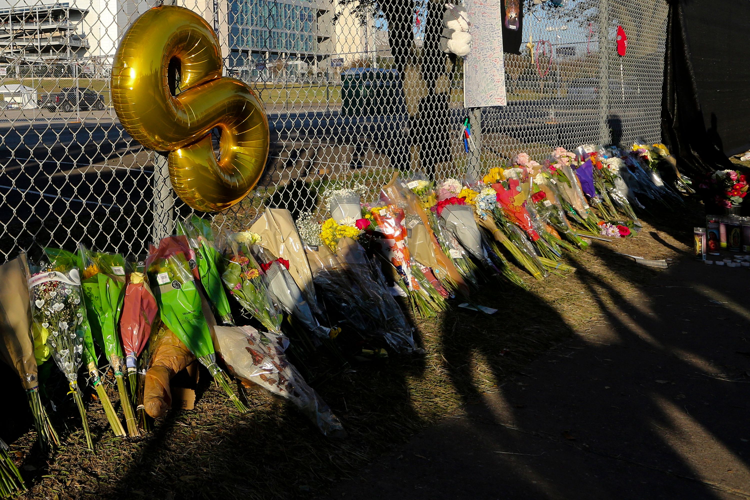 People attend a makeshift memorial on 7 November 2021 at the NRG Park grounds where eight people died in a crowd surge at the Astroworld Festival in Houston, Texas