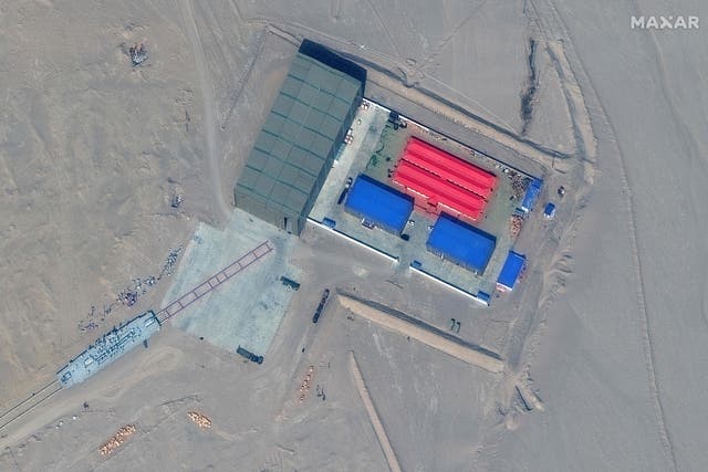 <p>This handout satellite image released by Maxar Technologies on November 8, 2021 shows a rail terminus and a target storage building in Ruoqiang county in the Taklamakan Desert, China's western Xinjiang region on October 8, 2021</p>