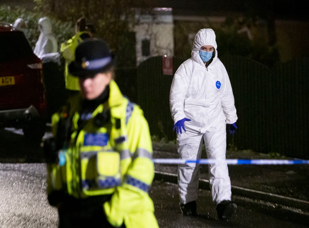 <p>Police and forensic officers at the scene of the attack </p>
