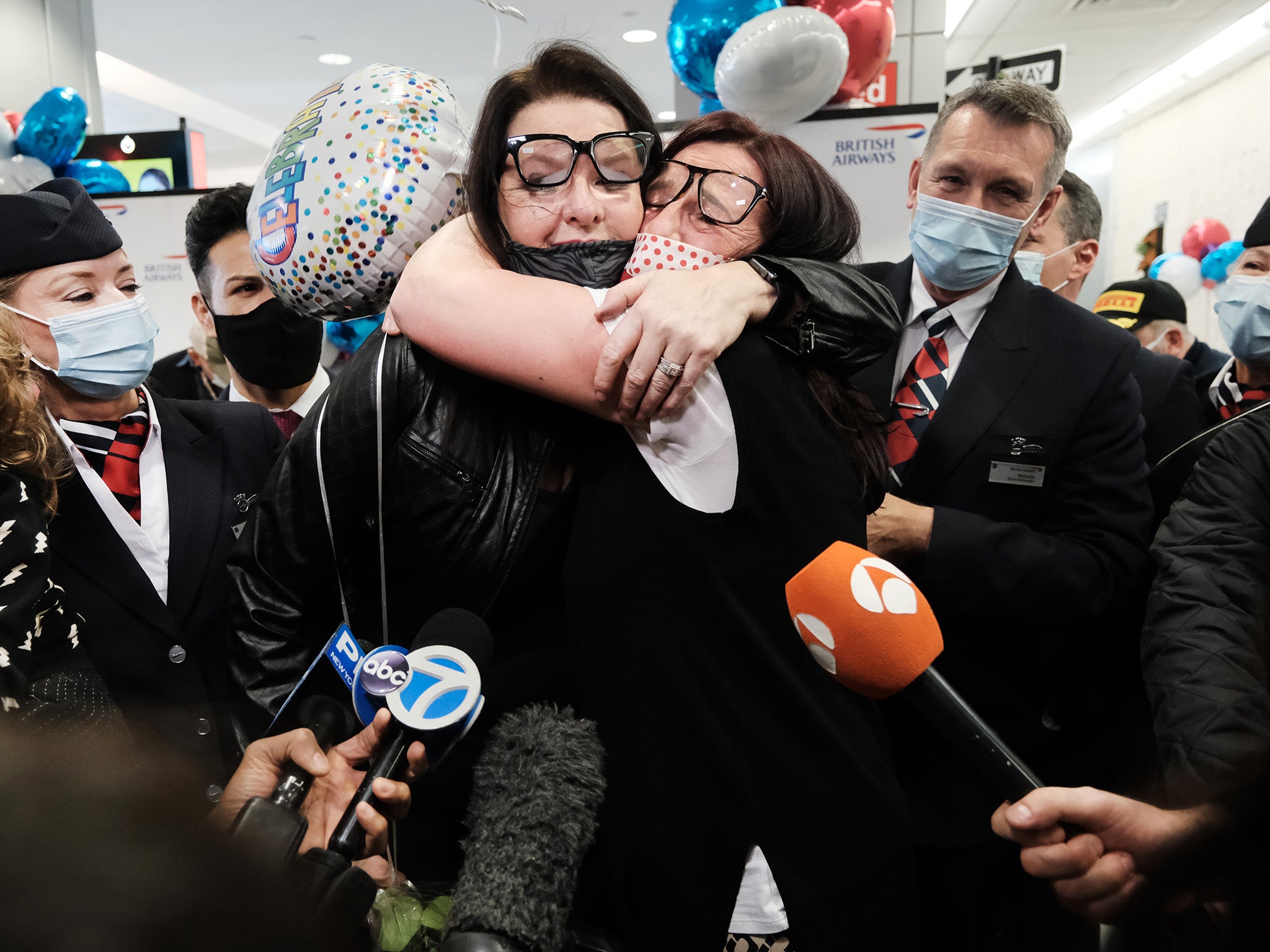 <p>Jill Chambers embraces her sister after landing in New York from London </p>