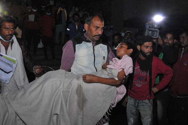 <p>A man carries a child out from the Kamla Nehru Children's Hospital after a fire in the newborn care unit of the hospital killed four infants, in Bhopal, India</p>