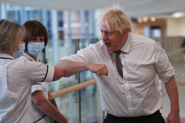 <p>A maskless Boris Johnson meets with medical staff during a visit to Hexham General Hospital in Hexham </p>