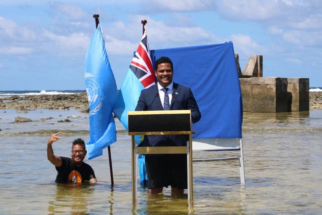 <p>Tuvalu minister Simon Kofe gives a Cop26 statement while standing in the ocean in Funafuti last week </p>