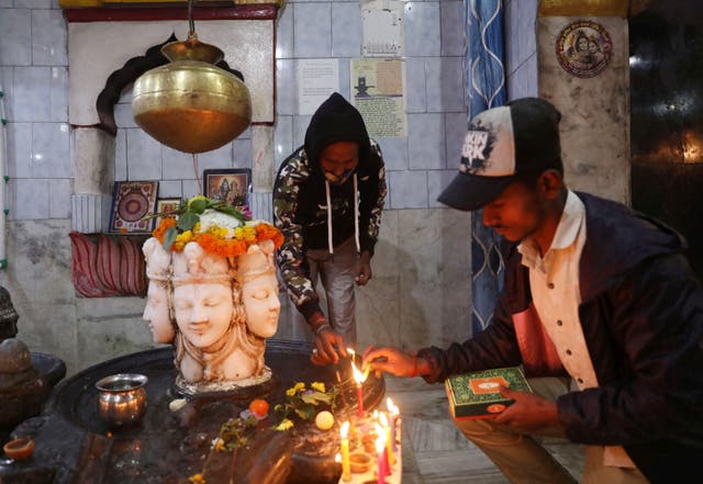 <p>File: Hindu devotees light candles at a temple in India on Diwali </p>