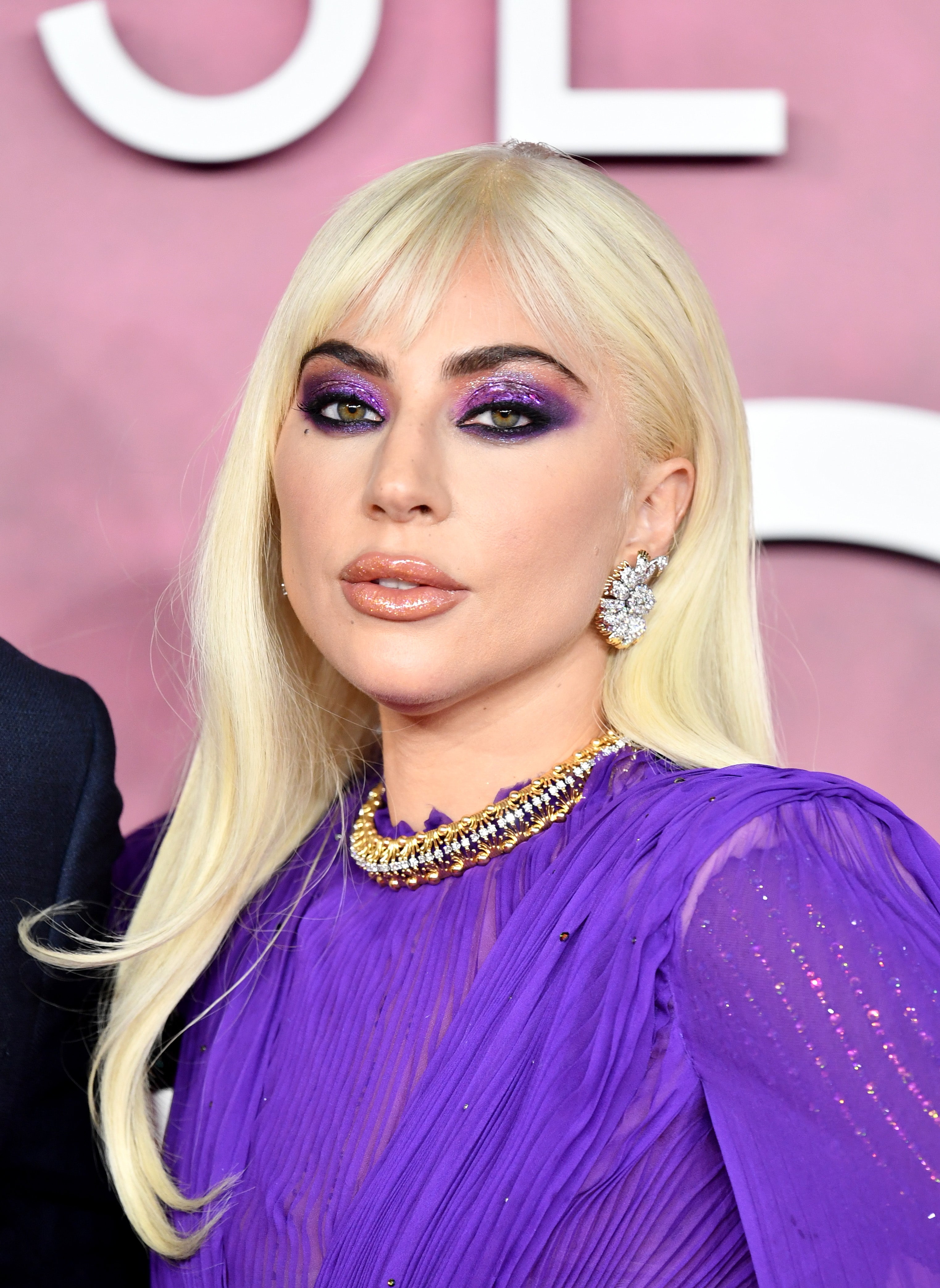 Lady Gaga wears a bold purple eye look at the House of Gucci premiere