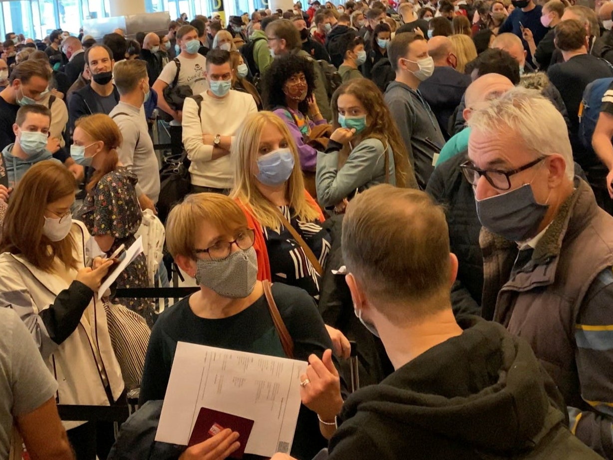 Travellers queue at the JFK International Airport in New York City