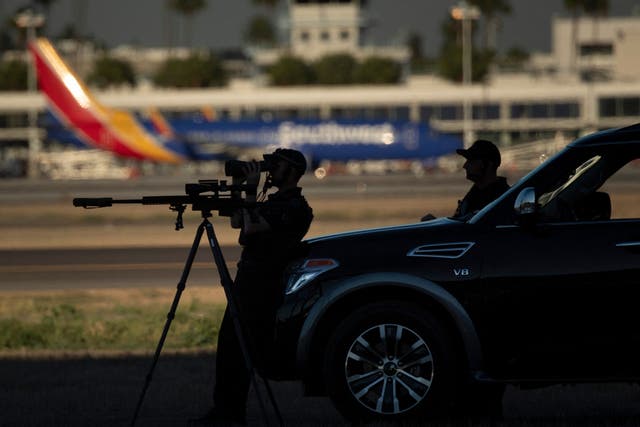 <p>Snipers stand guard as US President Joe Biden arrives at Long Beach Airport in Long Beach, California on September 13, 2021</p>