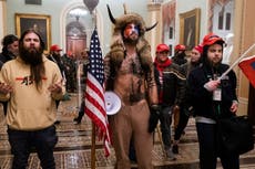 ‘QAnon shaman’ deserves four years in jail, prosecutors say – the stiffest 6 January sentence yet