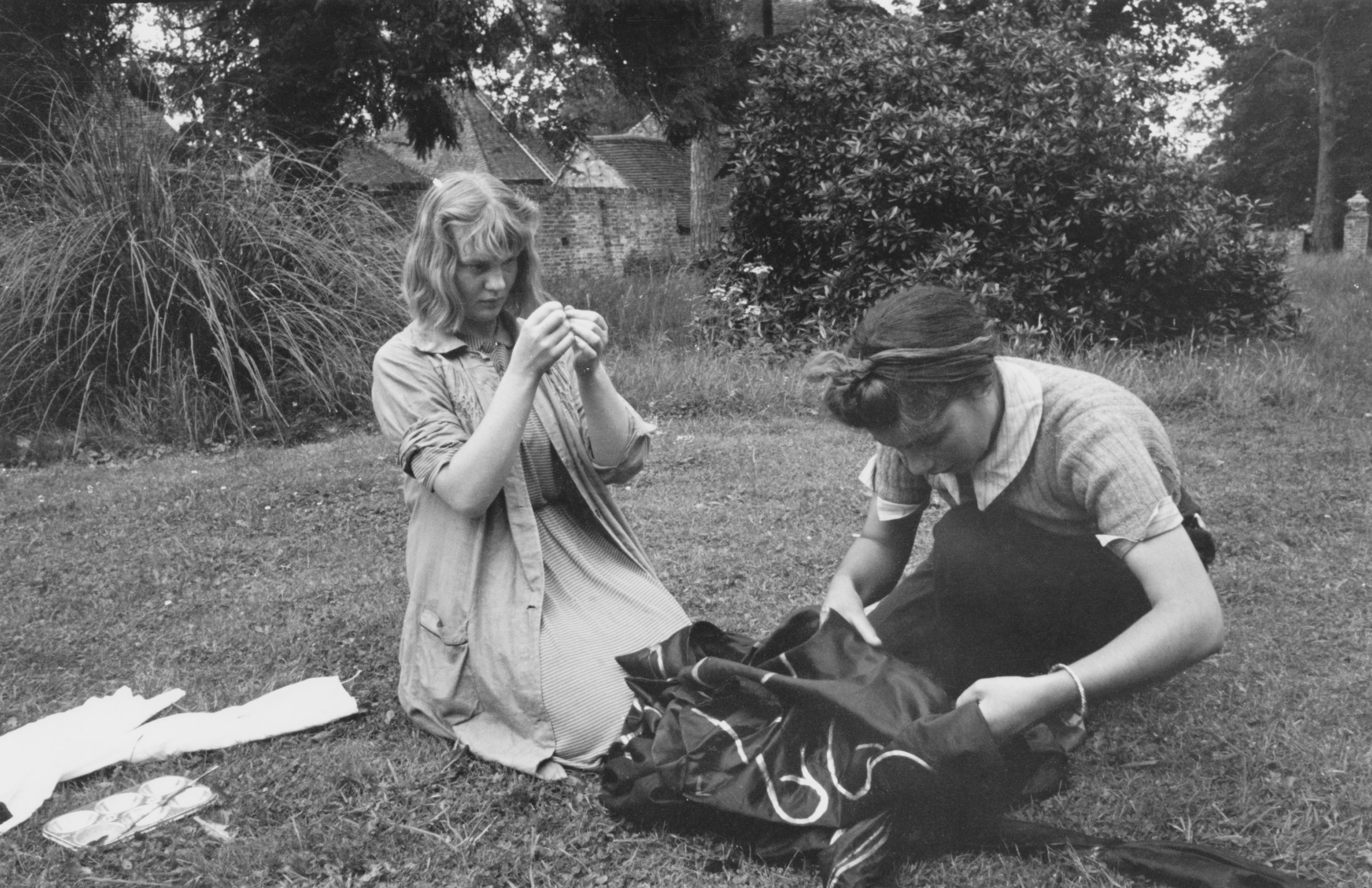 Murdoch helps mend costumes for an amdram company in 1939